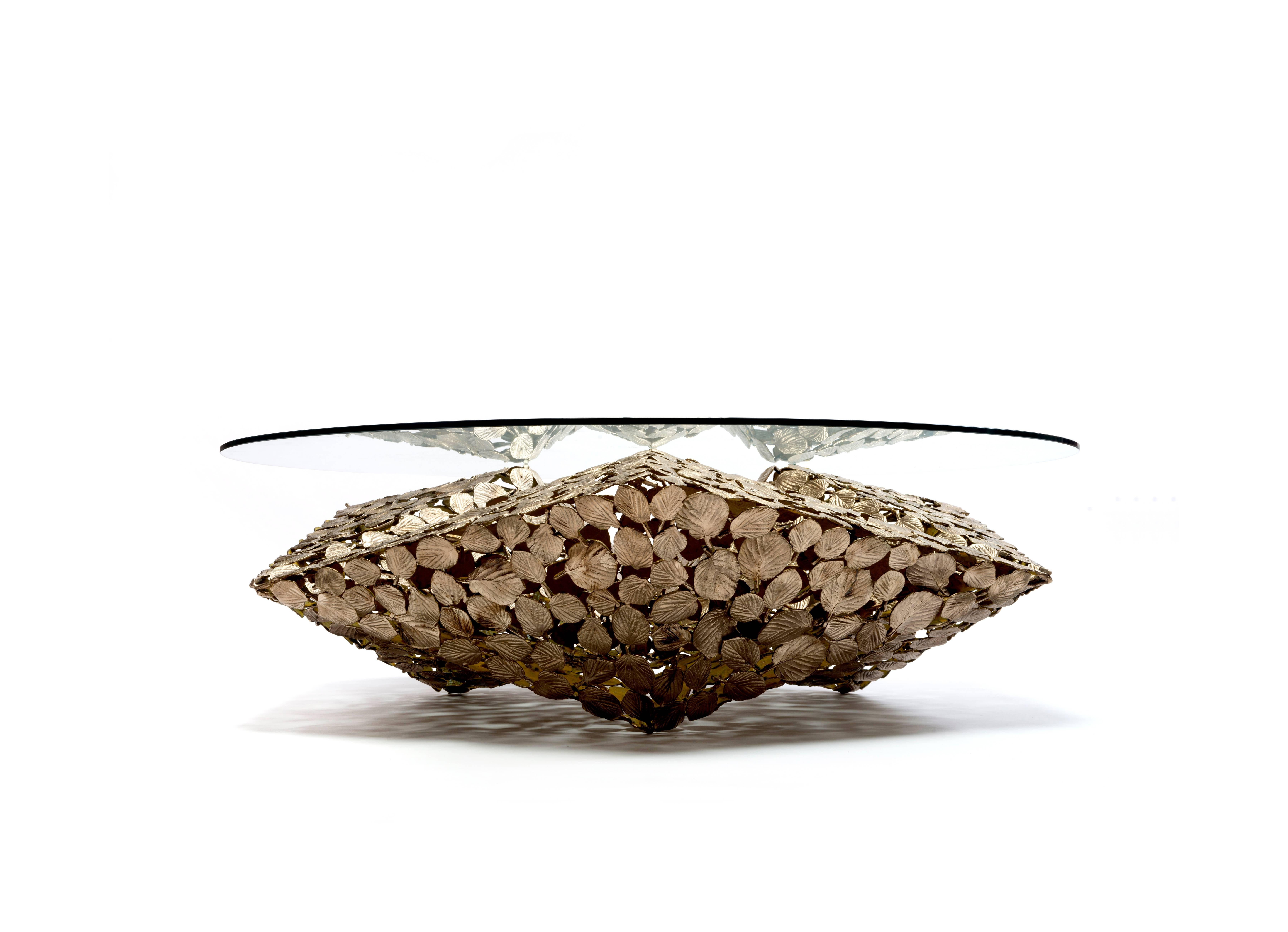 Stellated Spherical Spring table is fabricated by Gregory Nangle out of cast silicon bronze base with a glass top. The base is 53 x 53 x 16.5 inches and the glass is 56 x 56 x 0.5 inches.

The Gregory Nangle aesthetic explores what happens when