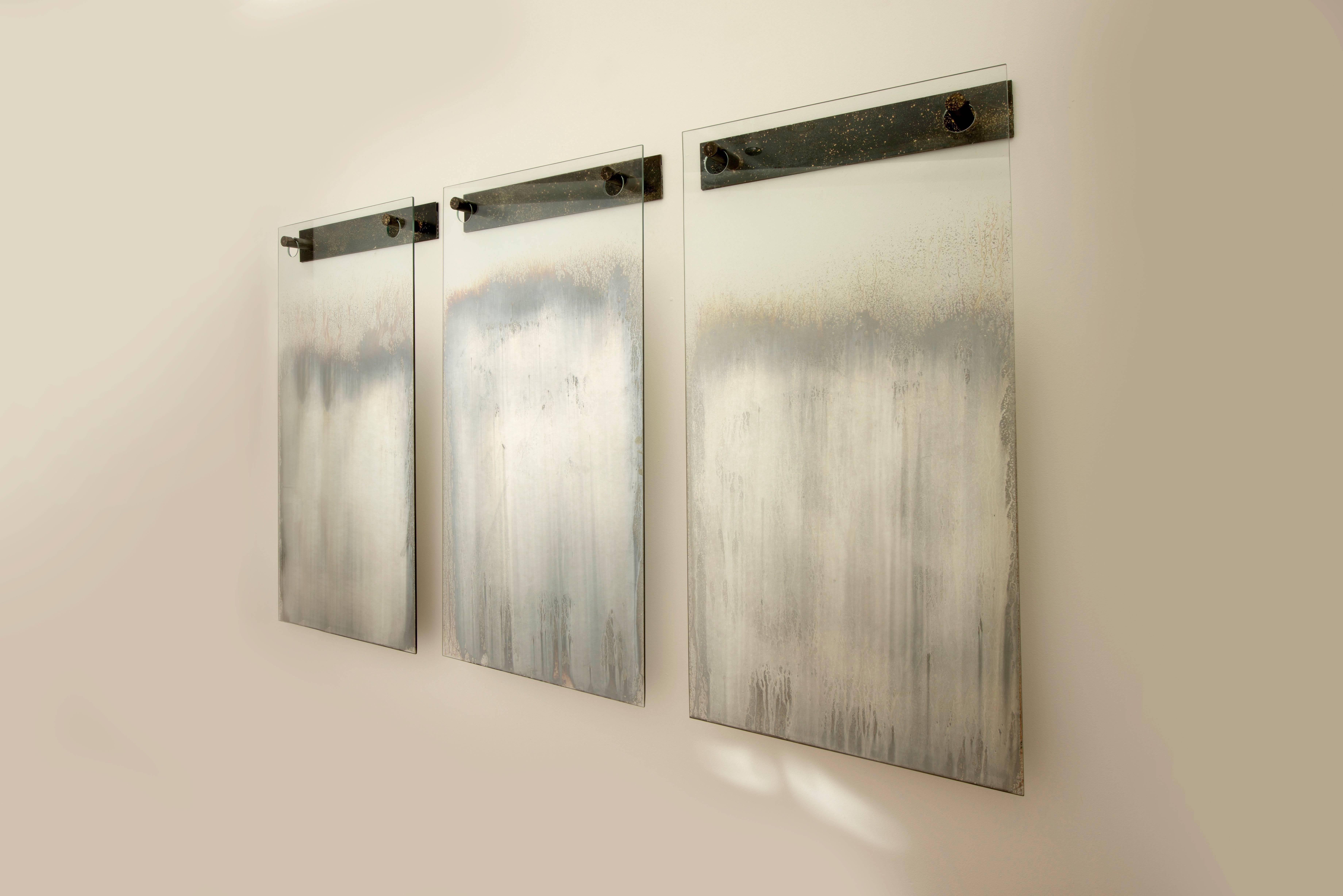 Triptych of three fading wall mirrors by Philadelphia artist/designer Gregory Nangle with custom bronze brackets.

   
