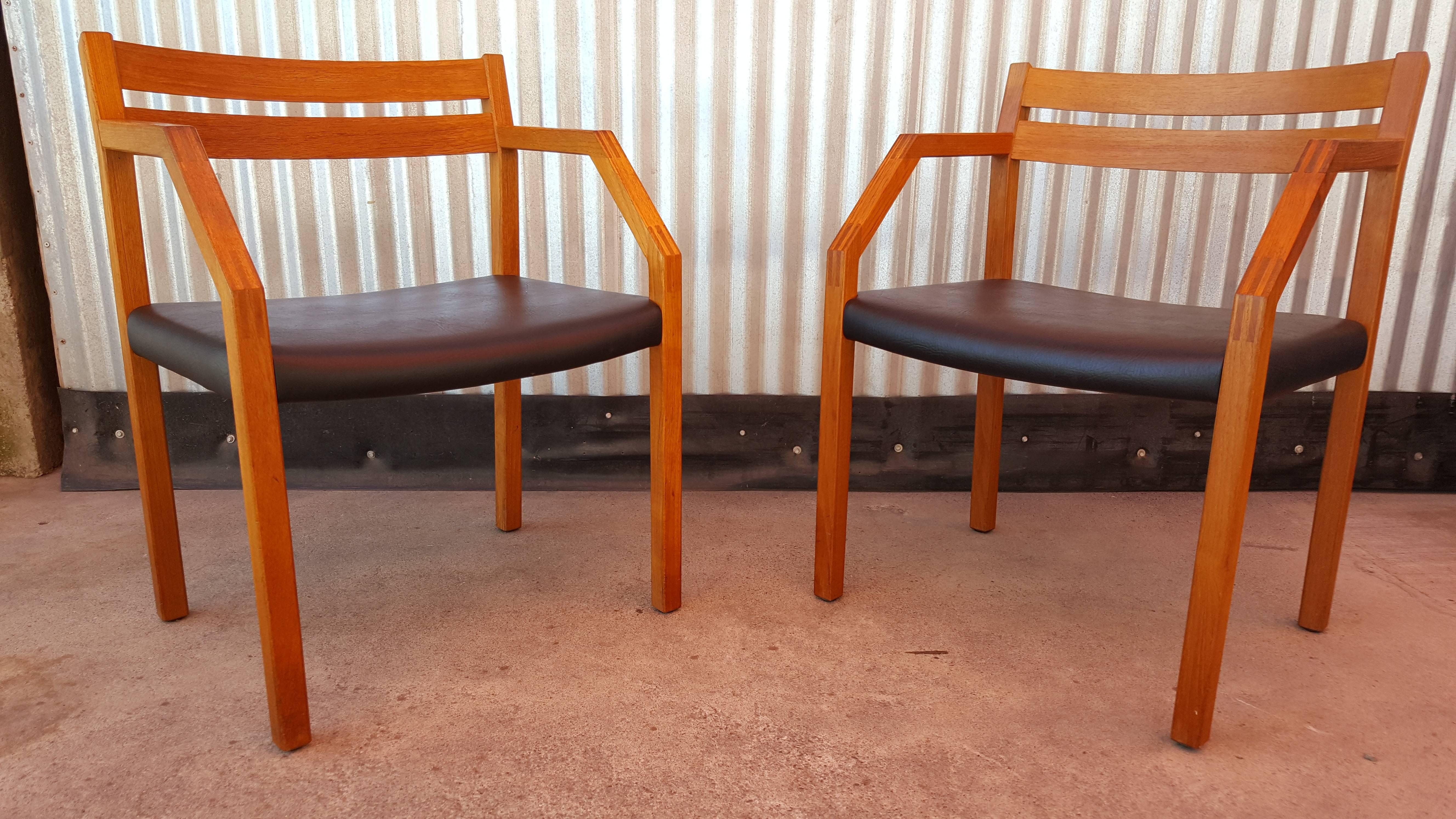 A pair of Danish Modern armchairs by Niels Otto Moller for J L Moller. Unusual, bold geometric design with finger-jointed detail. Retaining makers mark with beautiful original finish and original vinyl upholstery, also in excellent condition.