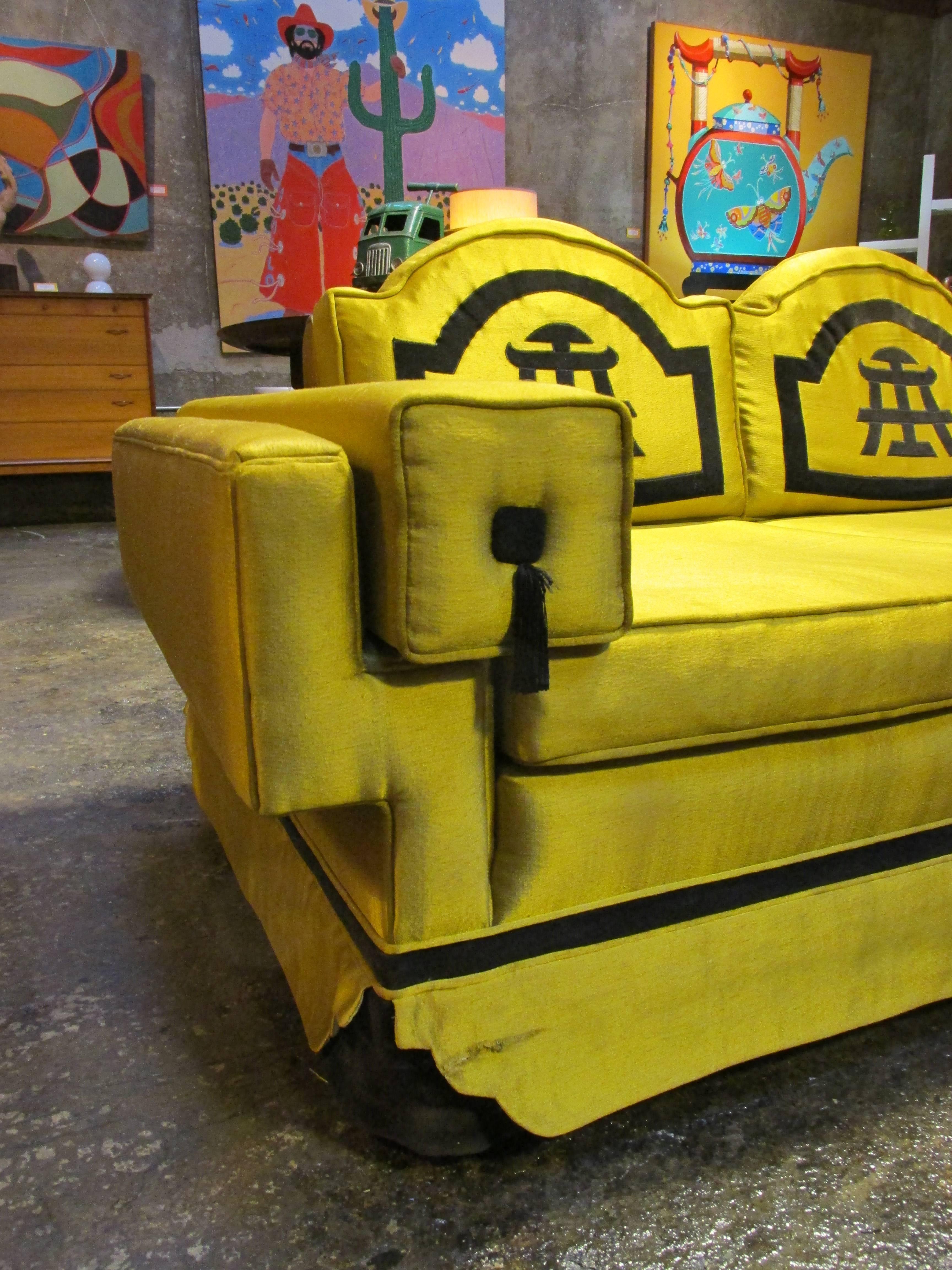 Classic oriental design to this 1950s American made sofa. Solid wood frame construction. A good, vintage template to reupholster and create a truly striking statement piece.