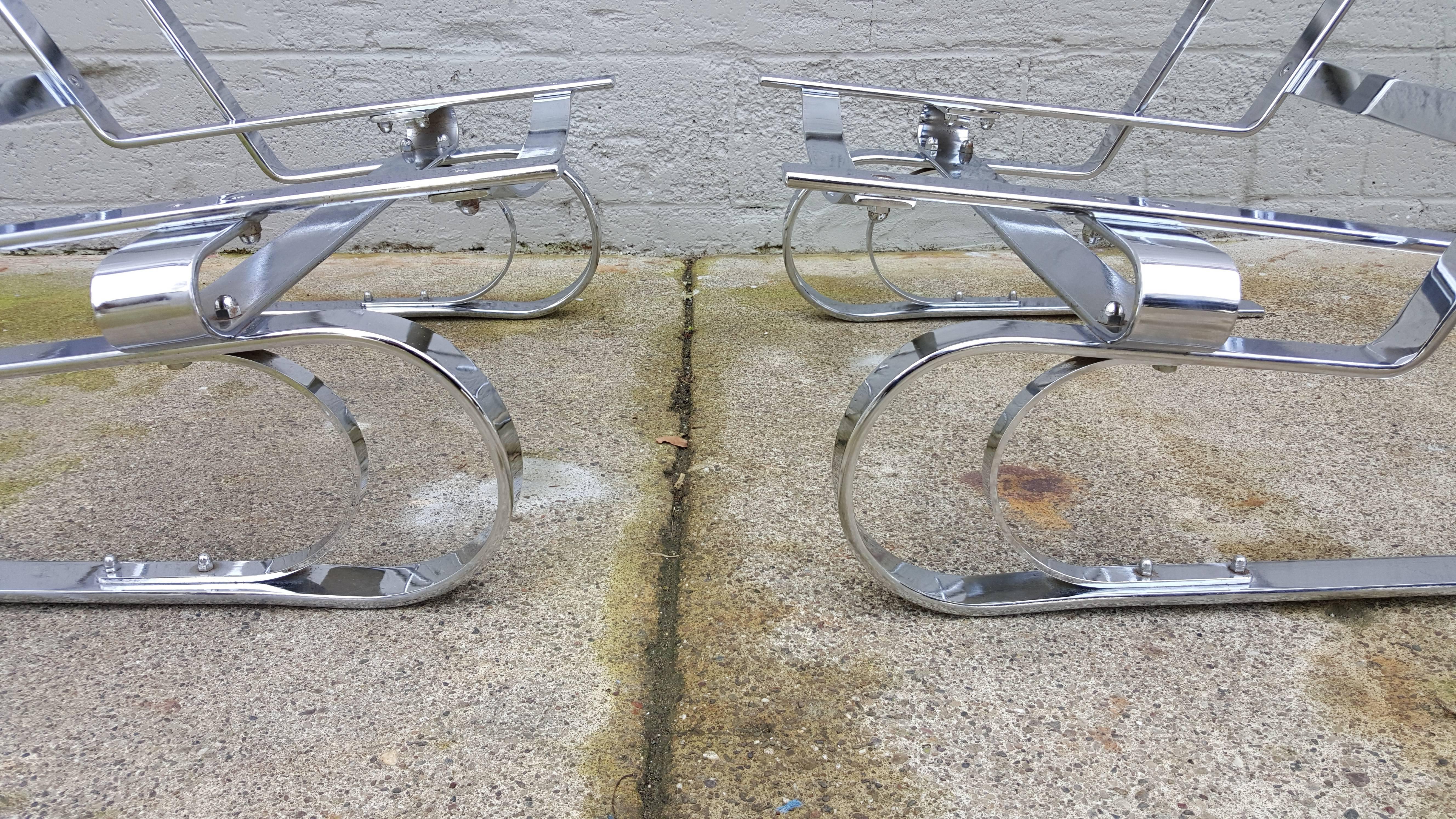 Here is a striking pair of heavy chrome steel high back cantilevered lounge chairs. These chairs resemble the designs of Arne Norell or the Poul Kjaerholm PK-20. Ready for the upholstery of your choice (not included). 11.5
