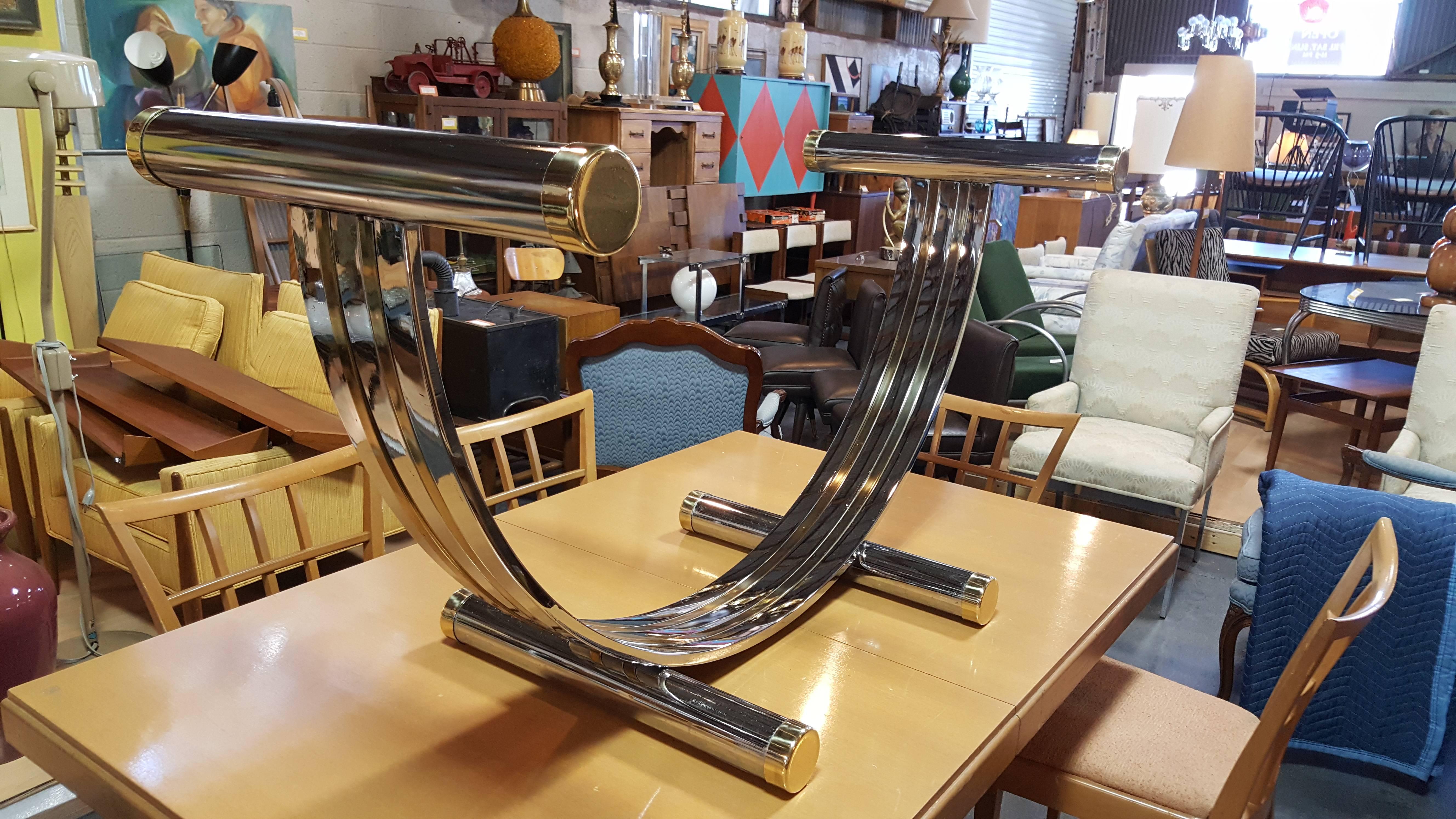 A 1970s modern chrome and brass dining table base attributed to Romeo Rega. Price reflects absence of glass top and gives one the opportunity to choose the precise form and size needed while eliminating expensive glass crating and shipping expenses.