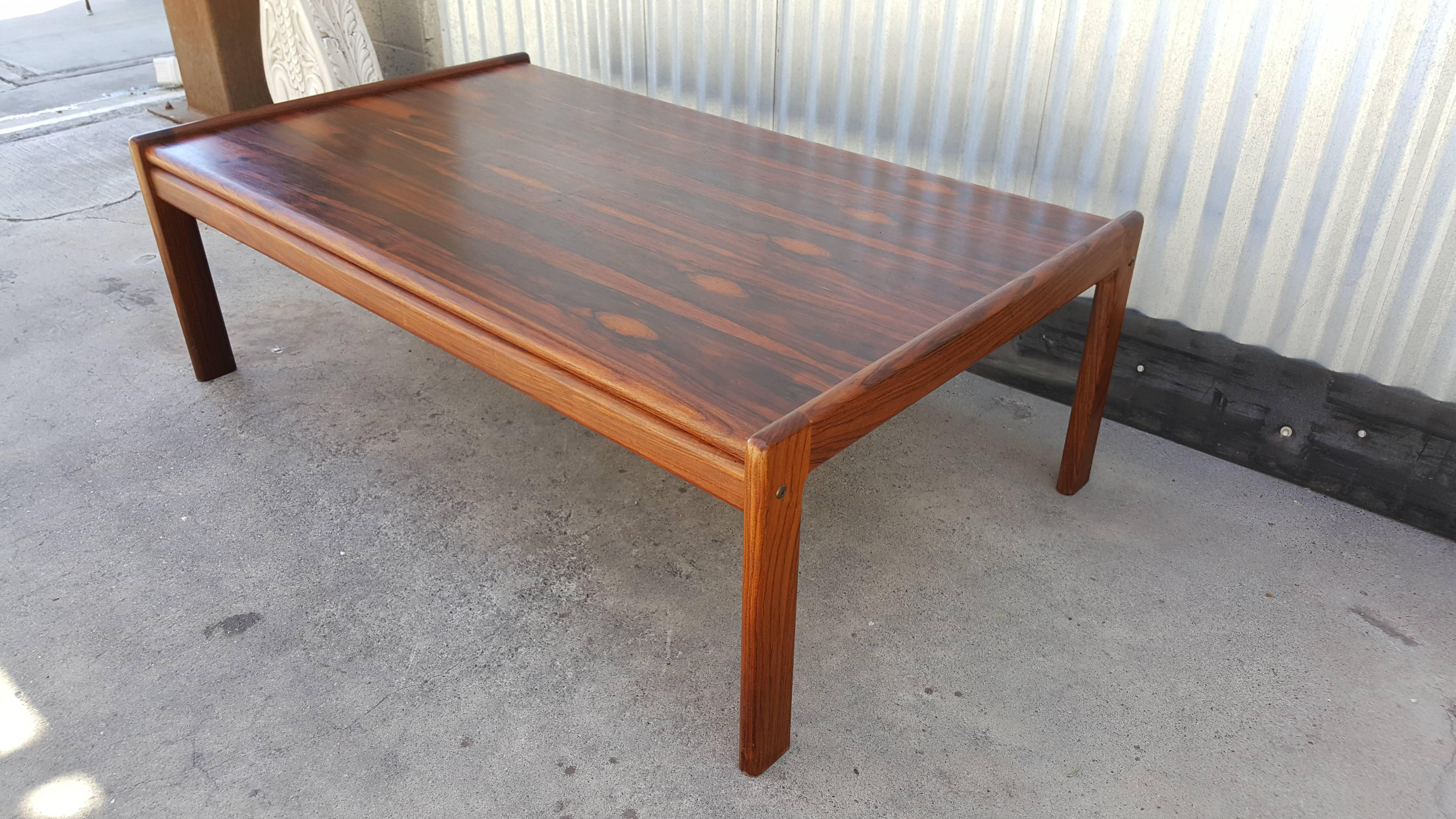 An oversized Danish Modern rosewood coffee table with exceptional figured wood grain, circa 1970.