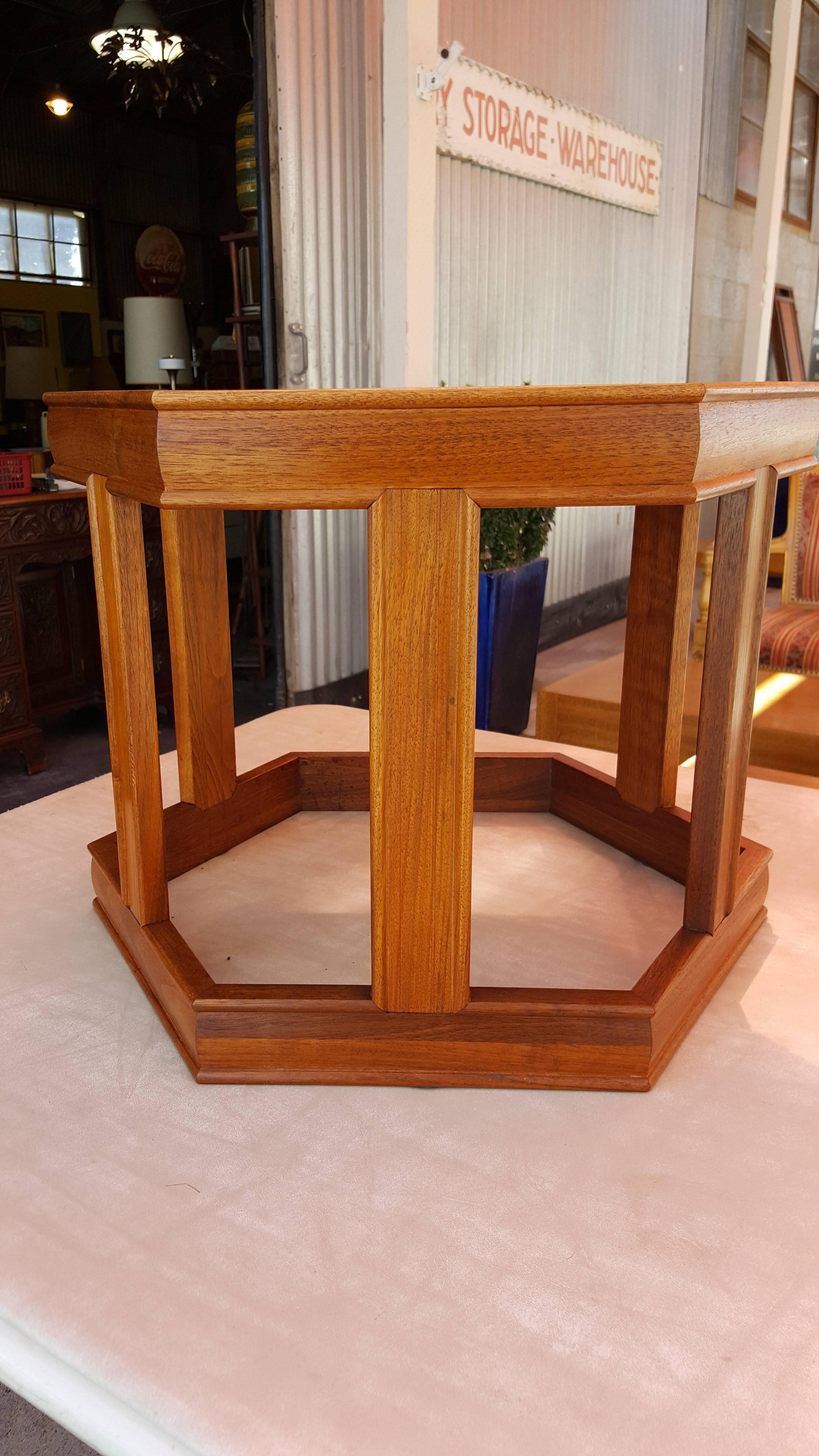 A hexagonal end table designed by John Keal for Brown Saltman, circa 1970. Made of solid walnut with a reverse glass top. Retains Brown Saltman label. This table can be shipped FedEx or UPS.