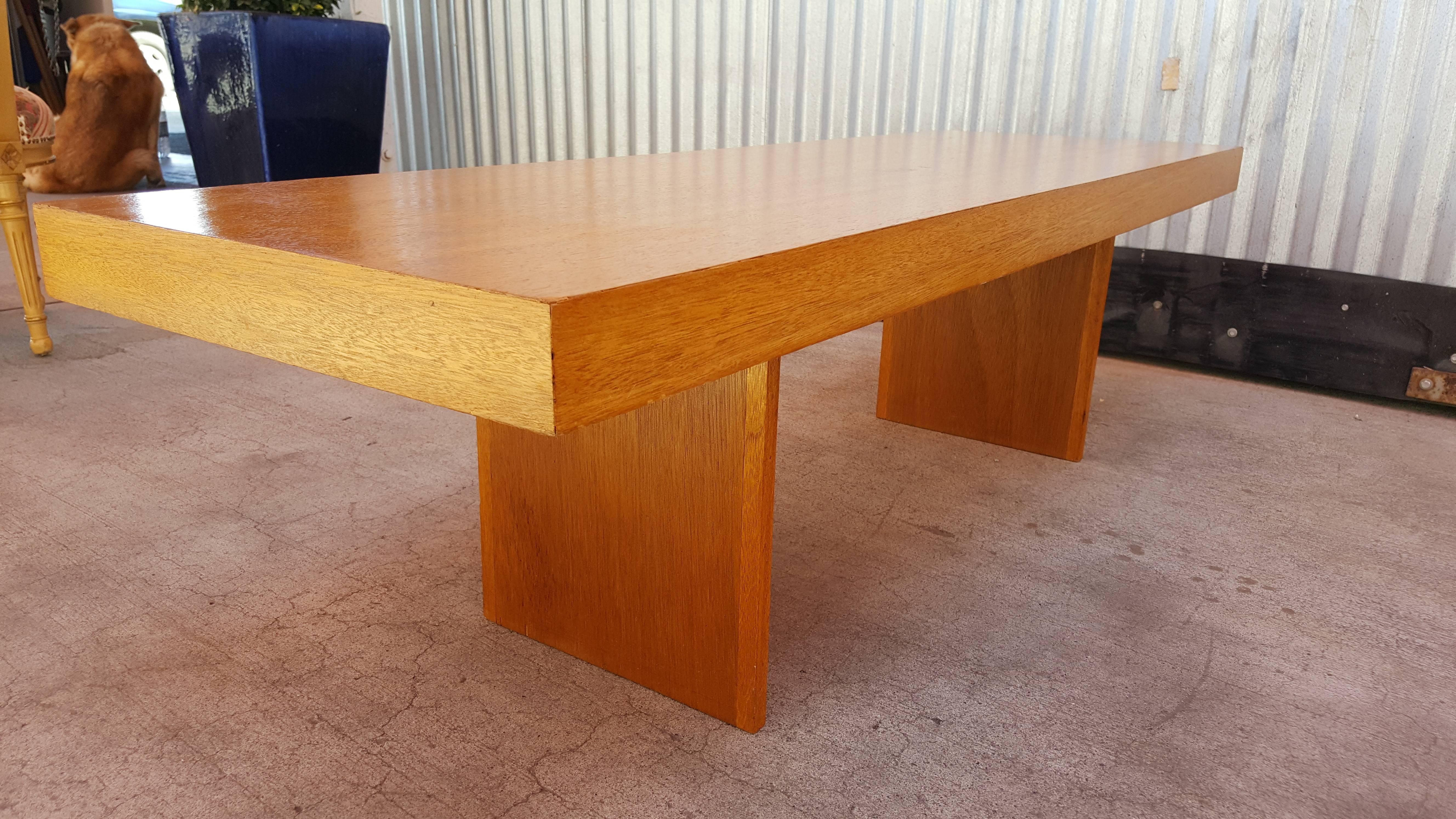A rectangular golden mahogany coffee table designed by John H. Howe. Originally from the estate of John H. Howe and his home, "Sankaku" in Minnesota which Howe designed in 1972. Howe was Frank Lloyd Wright's chief draftsman and architect