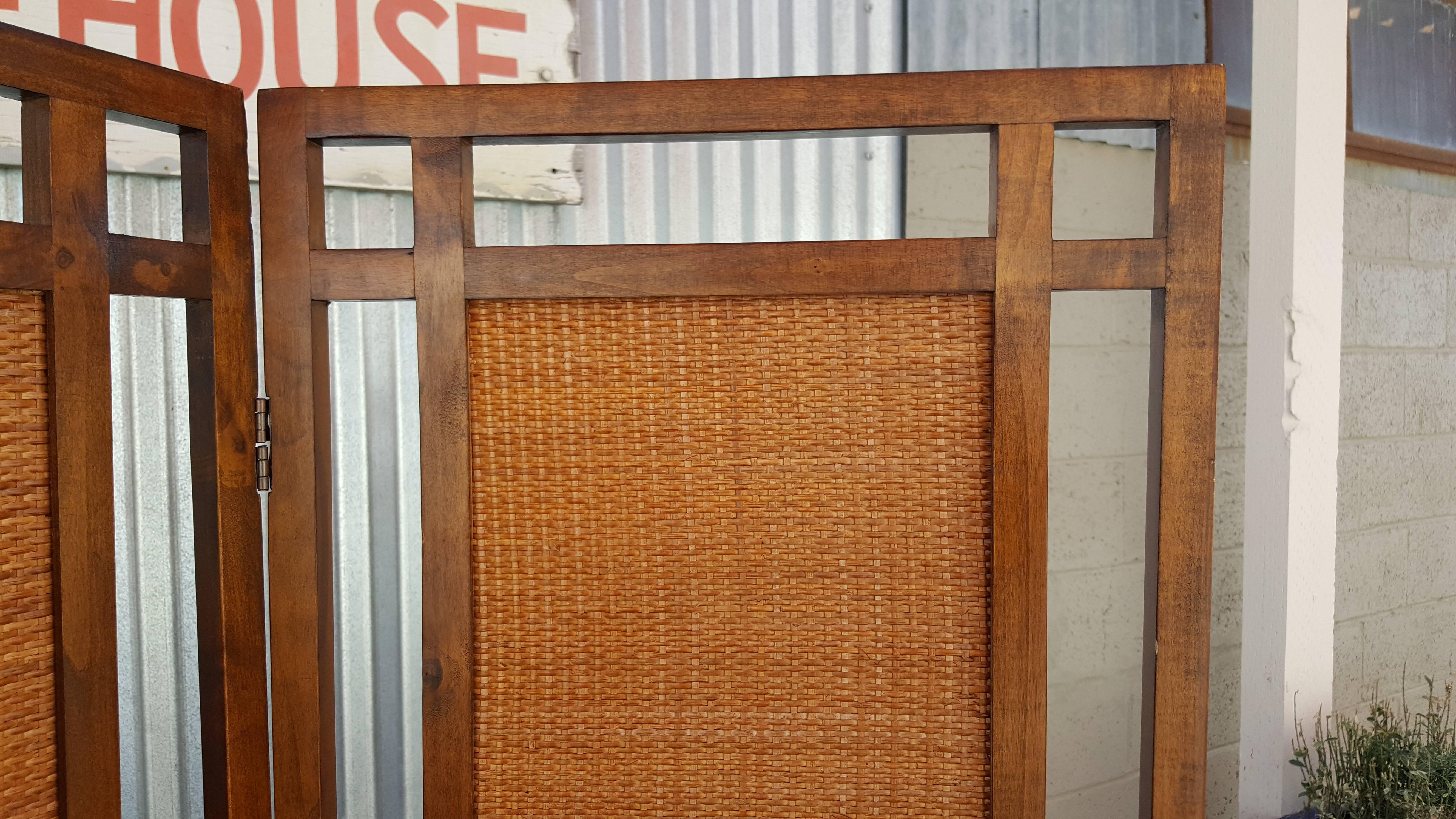 A 1960s Mid-Century Modern room divider with rectangular woven rattan panels. Nice architectural design. Each of the three panels measure 17.75