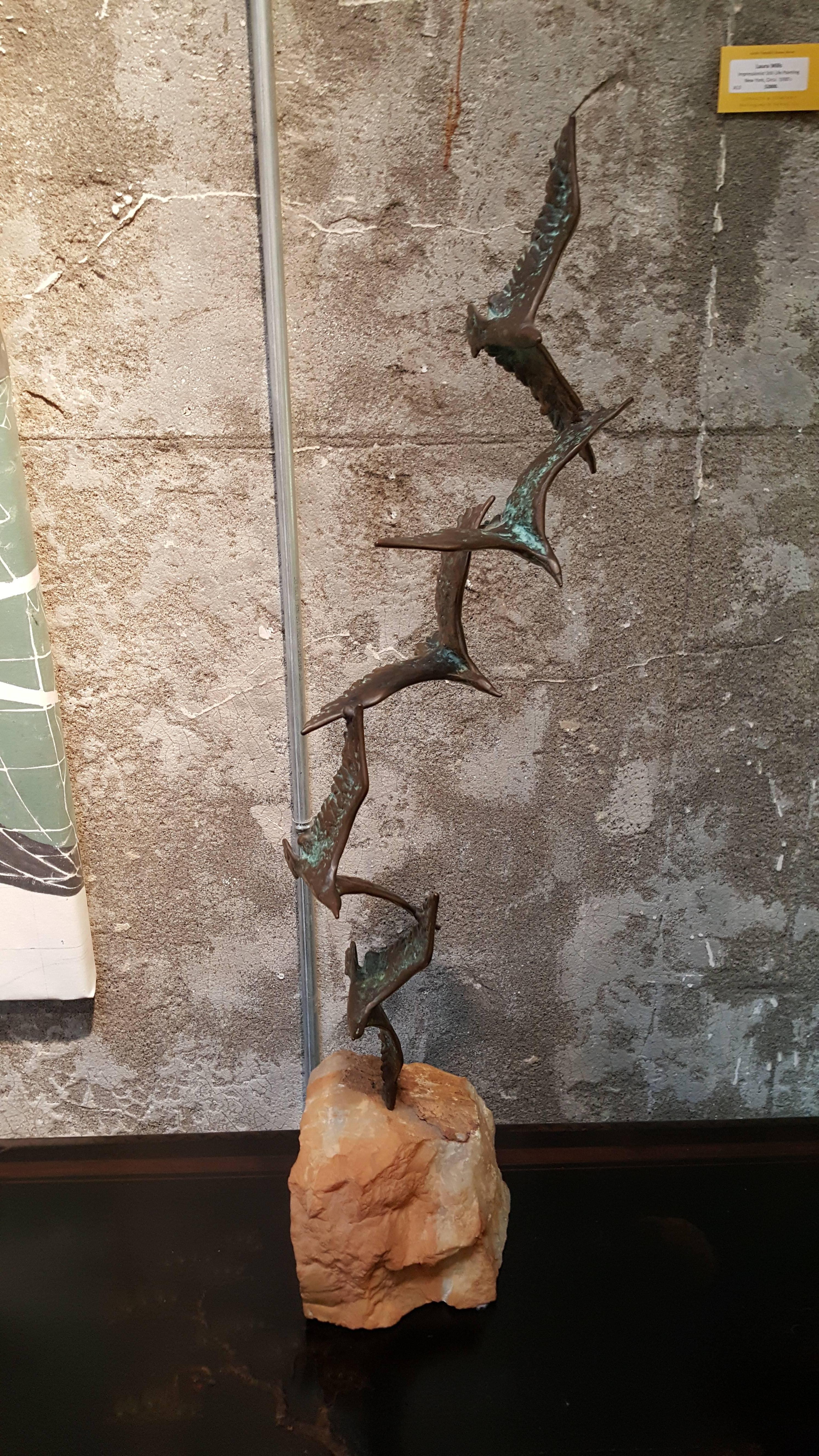 A bronze sculpture of birds in flight mounted to a quartz base. Signed C. Jere. 1972. Excellent condition with original patina. Measures 31.5" tall.