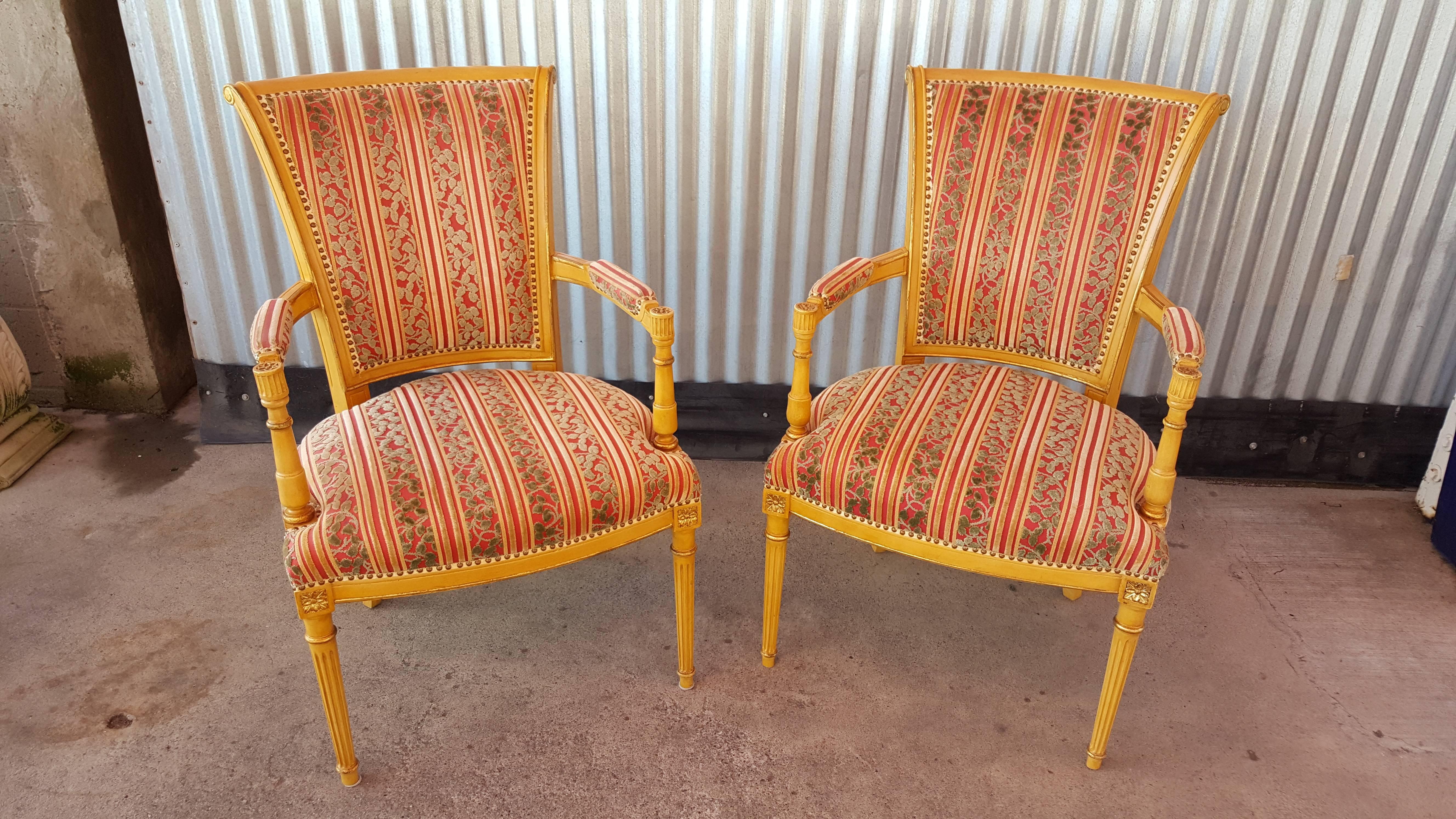 A beautiful pair of Louis XVI style armchairs with fine attention to detail. Original painted surface and fabric. Retaining the Lx Rossi label. Late 20th century.