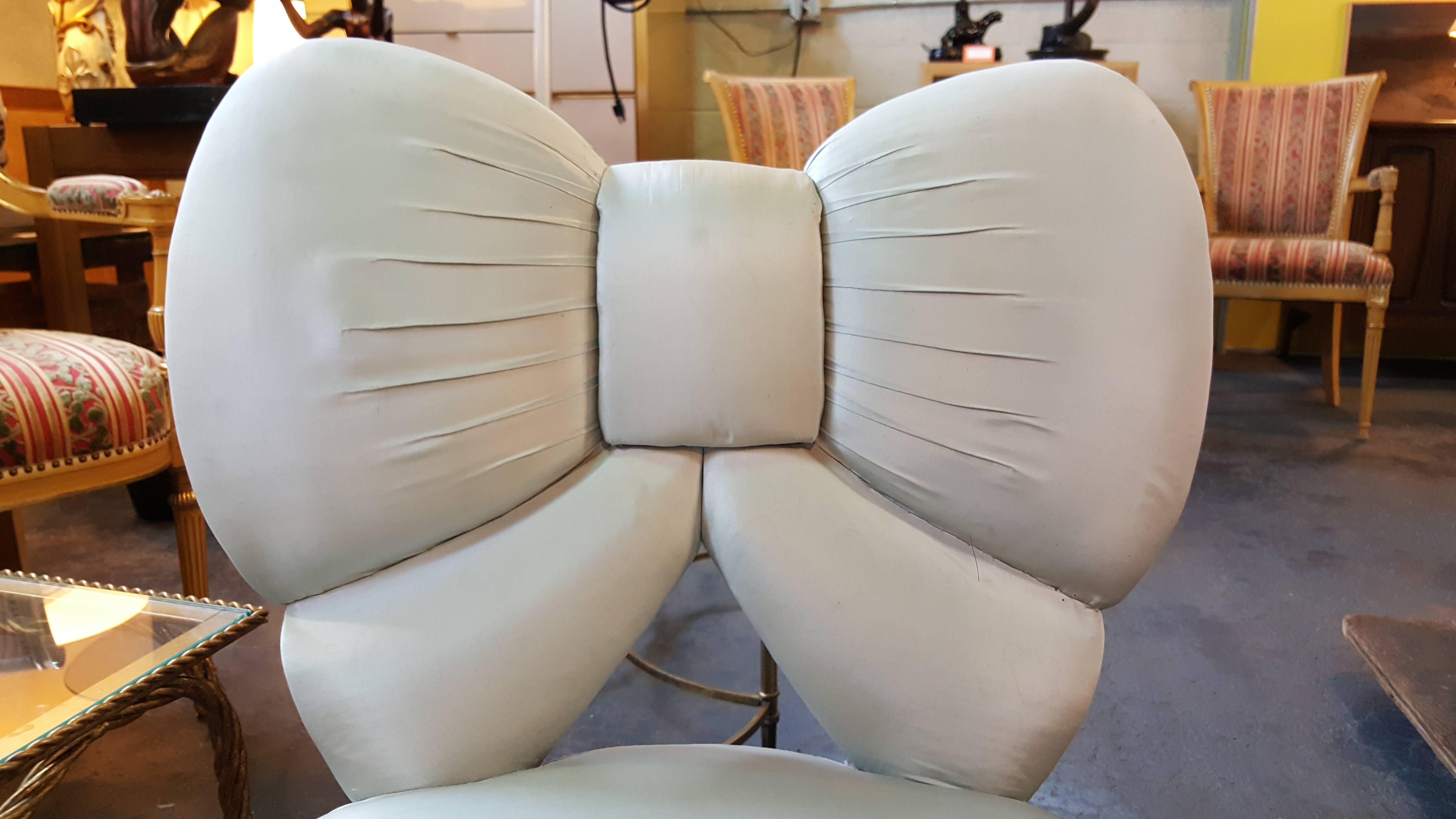 A unique 19th century American Victorian slipper chair with the form of a bow for the backrest. Great for use as a vanity chair, a desk chair or an accent chair. Lots of personality in this one. Option to re-upholster without dust ruffle, exposing
