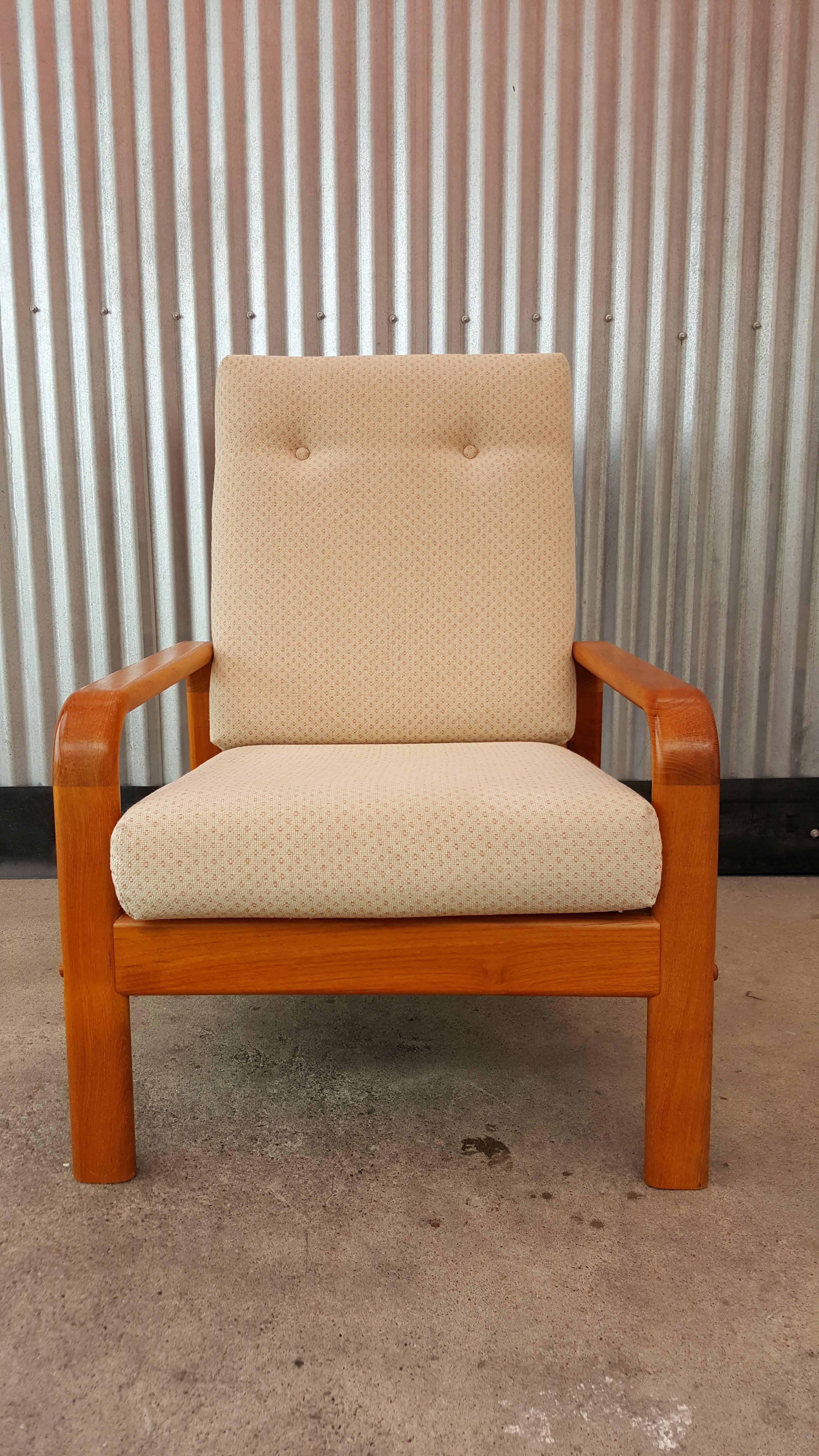 A very comfortable high back lounge chair crafted in solid teak. Classic bent arm design with a solid teak slatted back. Reversible cushions.
