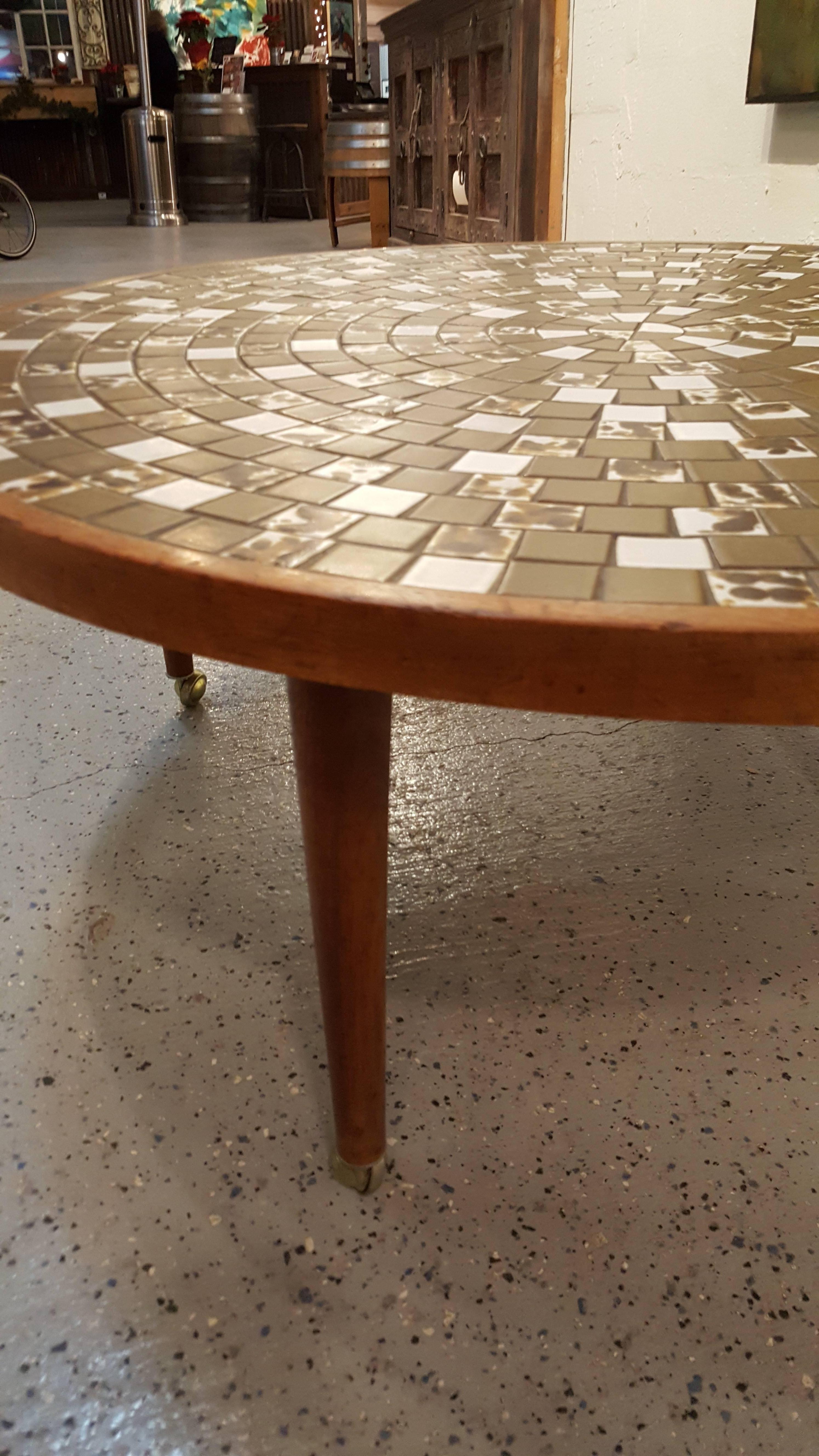 A Mid-Century Modern circular mosaic tile coffee table by Gordon & Jane Martz for Marshall Studios. Circa 1960s. Solid walnut frame and conical 