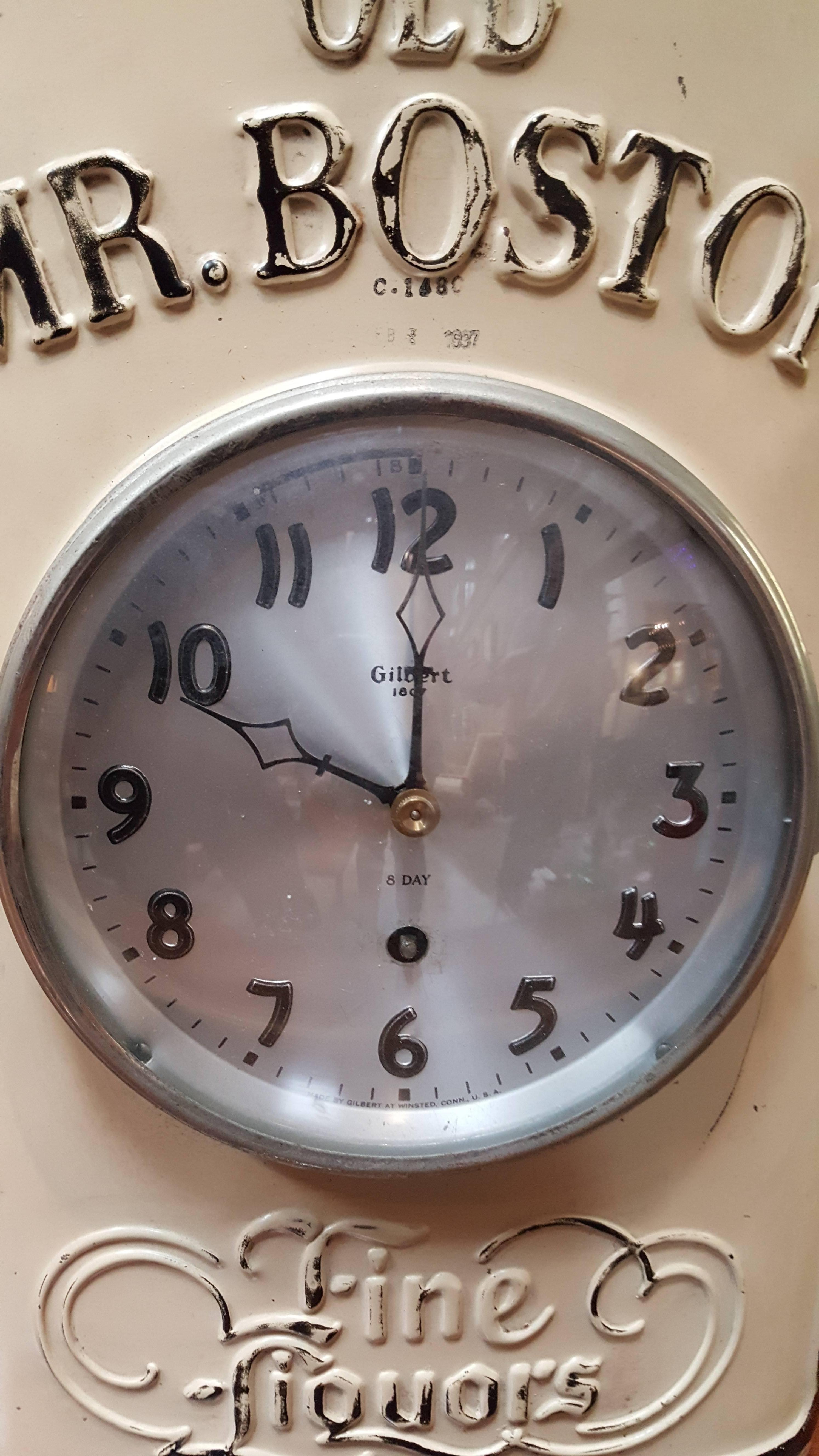 A 1930s store advertising clock for Old Mr. Boston liquors. Original painted metal finish, dated 1937. Gilbert key-wind clock intact but not in working order. Very nice original condition. Measures 21.5