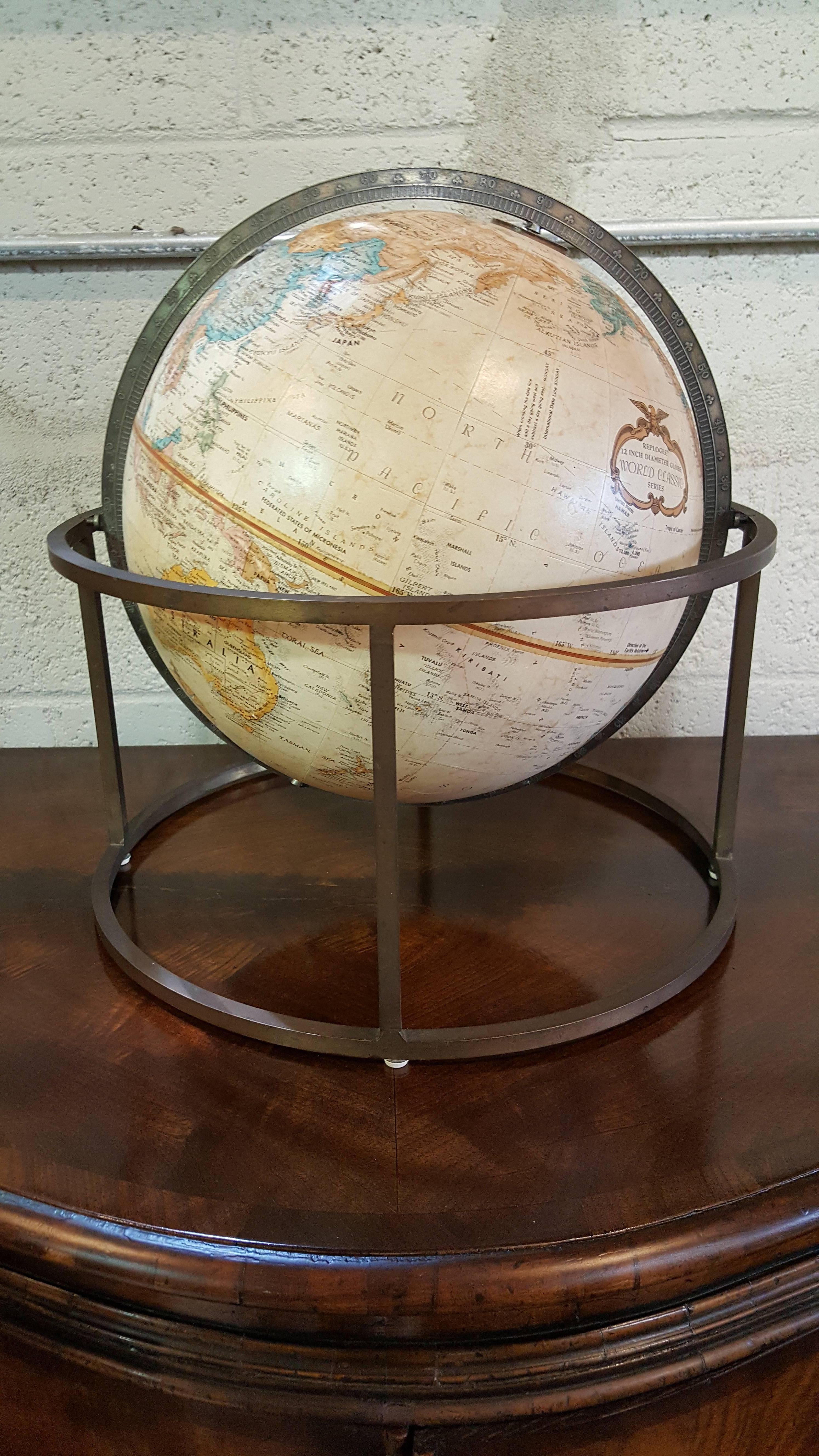 Tabletop world globe with square tubular brass stand by Replogle.
Attributed to Paul McCobb, circa 1960s. Nice patina to metal base, globe in excellent condition.