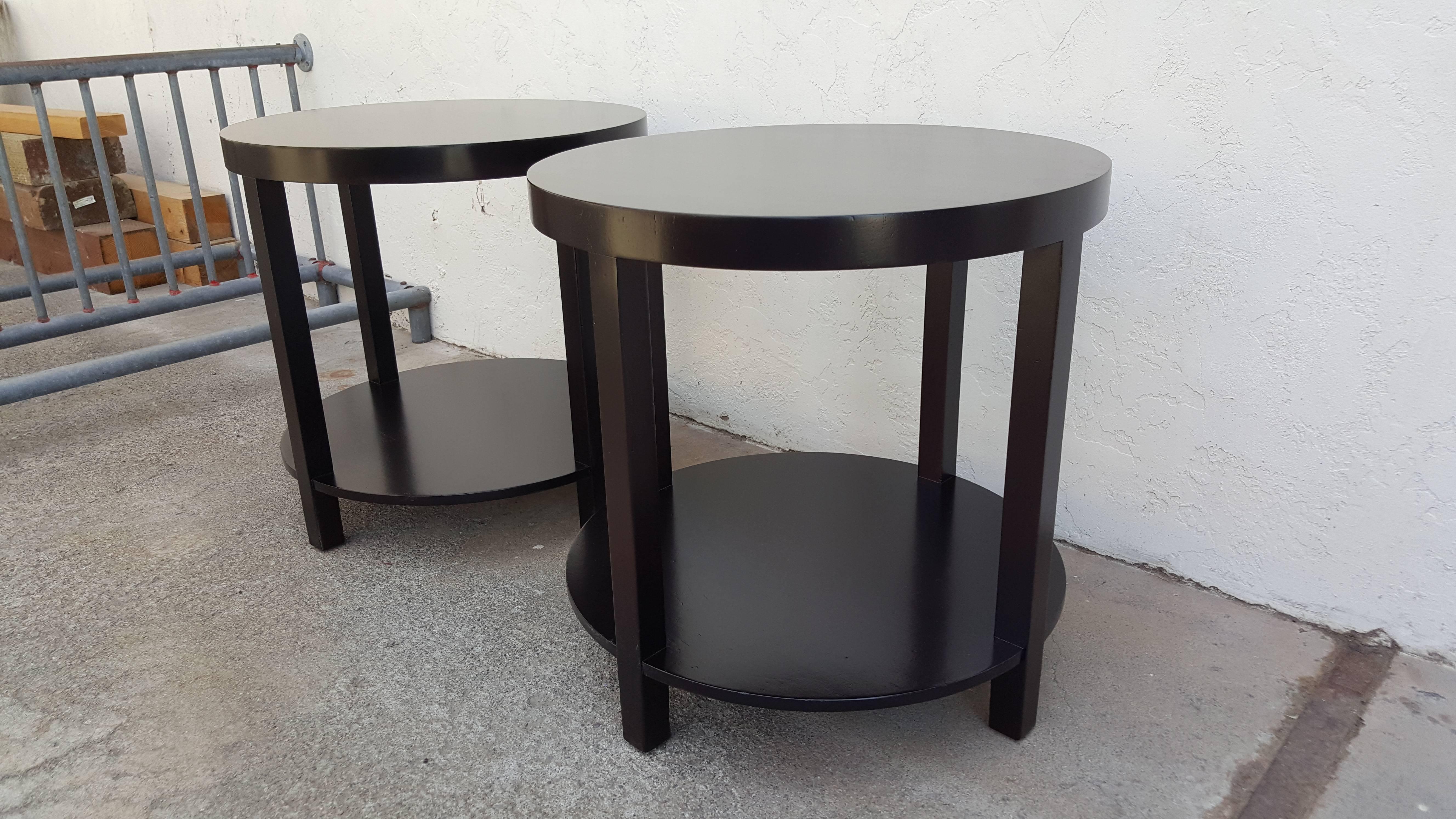 A pair of circular end tables designed by Robsjohn-Gibbings for Widdicomb Furniture, circa 1950s. Refinished in a chocolate brown lacquer. Retaining Widdicomb label.