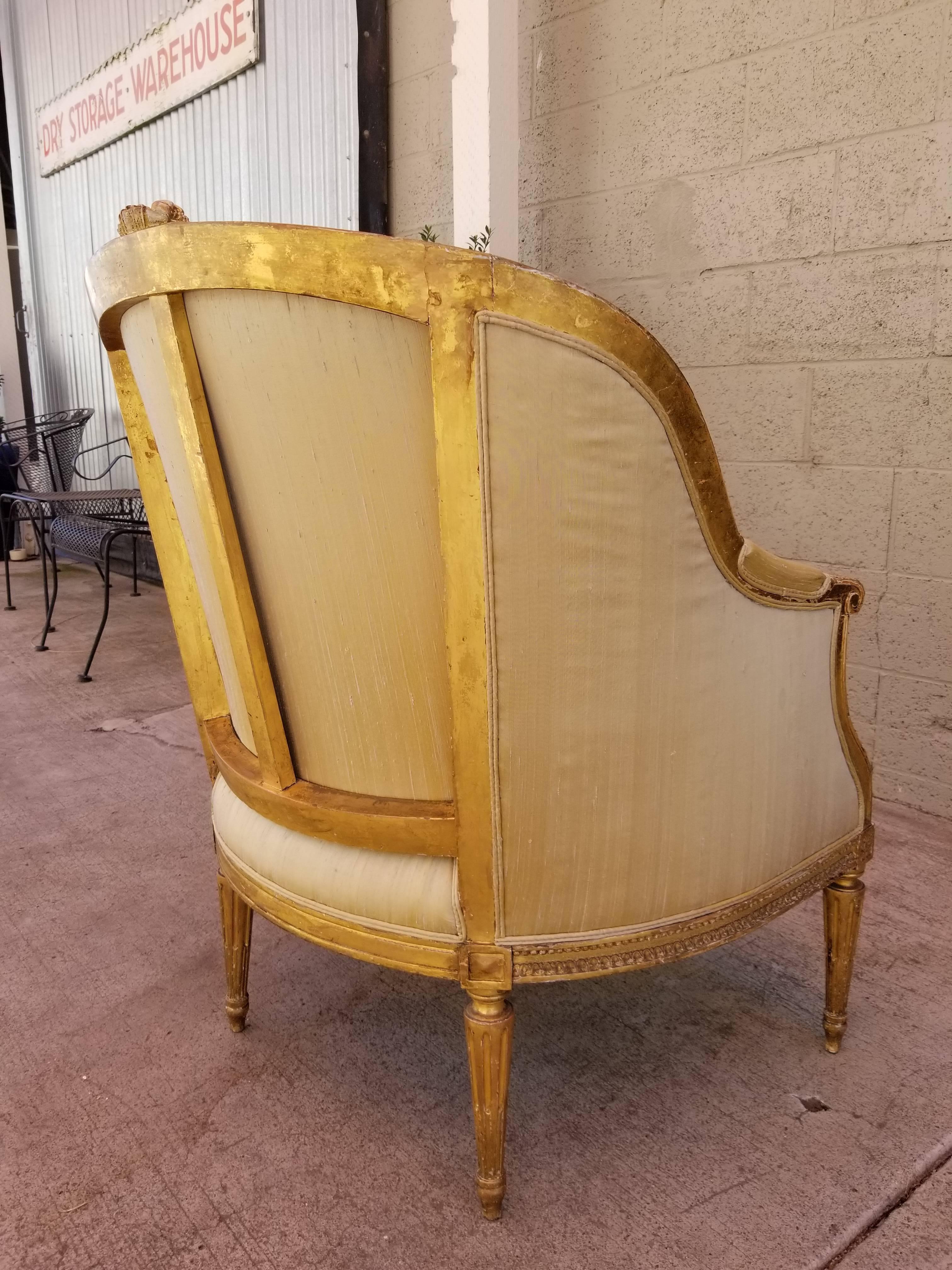 Superb detail and proportion to this 19th century gilt Louis XV style bergere. Silk upholstery with down cushion.