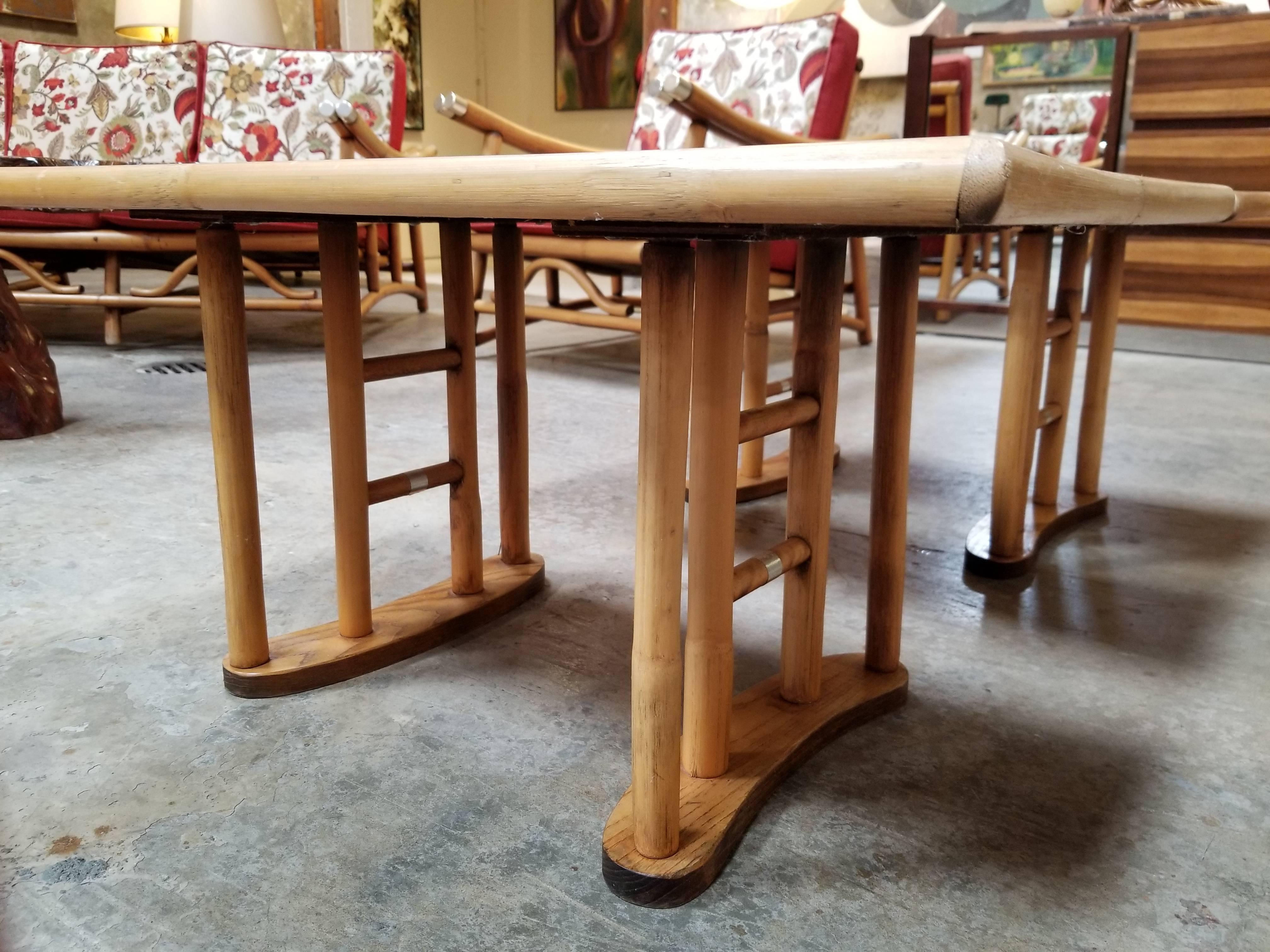 Pair of rattan end tables with faux wood grain formica tops.