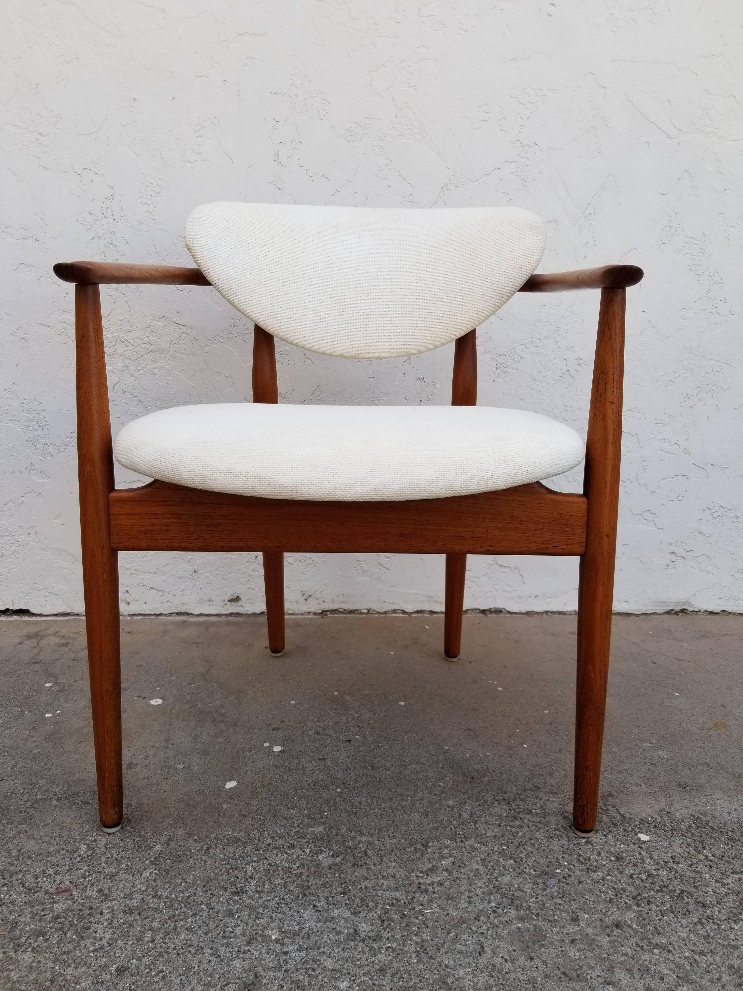 Four teak dining chairs attributed to Finn Juhl. One armchair and three side chairs. Similar to models Nv 55 and 108

Vintage fabric has been professionally cleaned, chairs frames professionally cleaned and polished. Chairs have older, minor