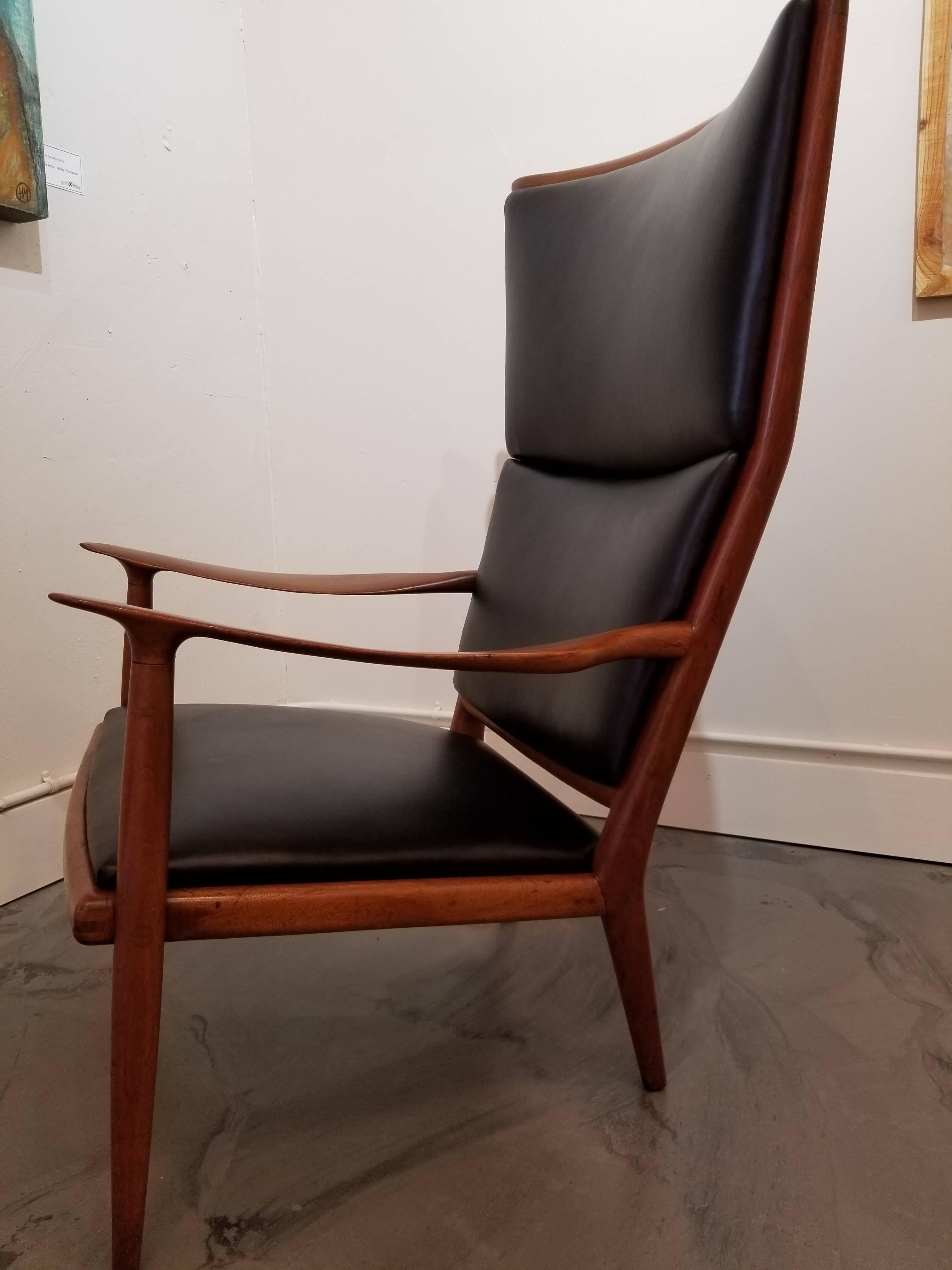 An important sculptural black walnut lounge chair and accompanying foot stool by Sam Maloof. Beautiful glow to original finish. Newly upholstered in black leather. Both pieces signed. Foot stool measures 23.88
