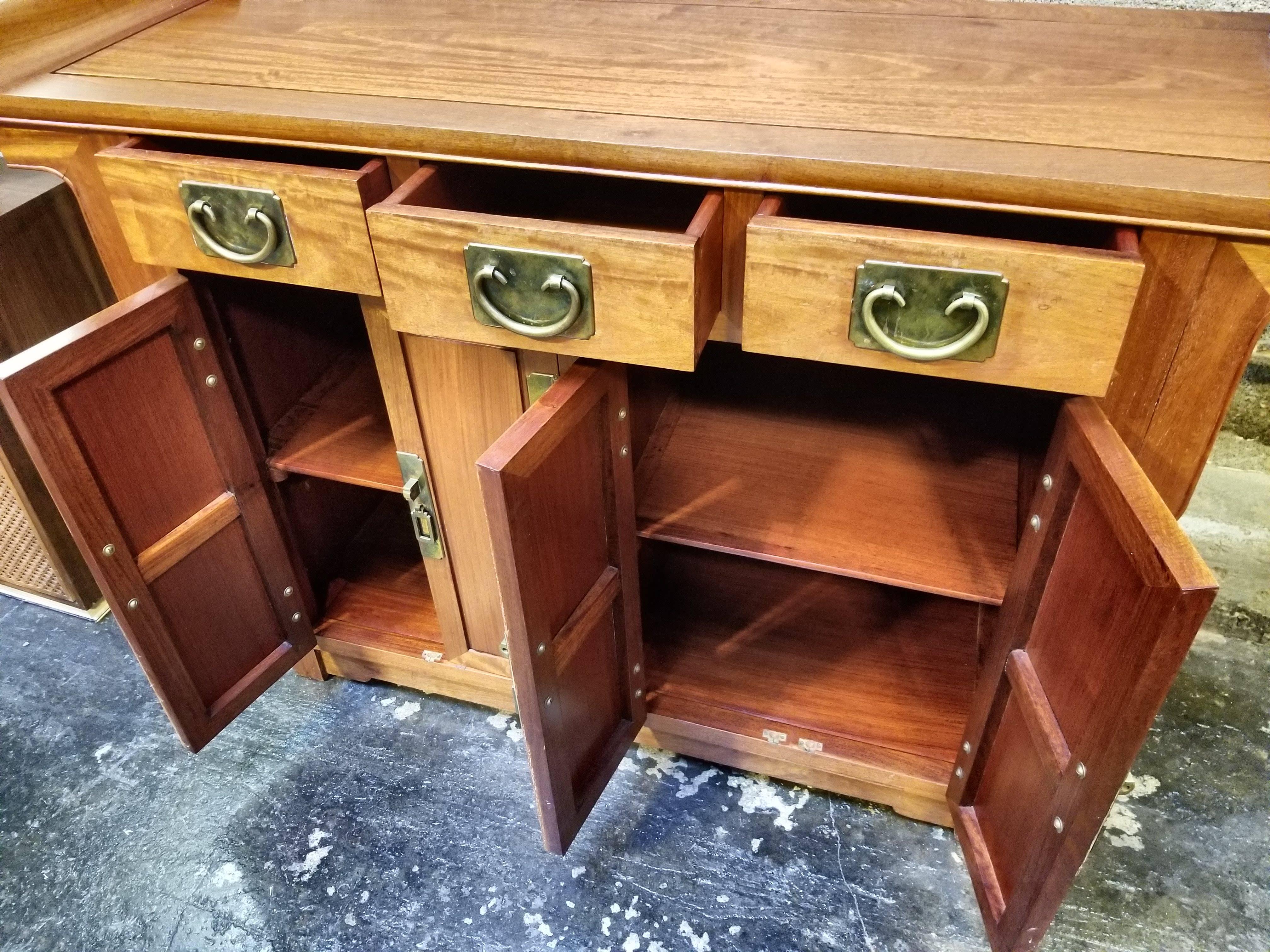 A fine Chinese Ming style cabinet made by George Zee Furniture Company. Works well as a console table or credenza. Amazing craftsmanship and materials in this piece as it is made entirely in a solid mahogany including the secondary woods. Notice