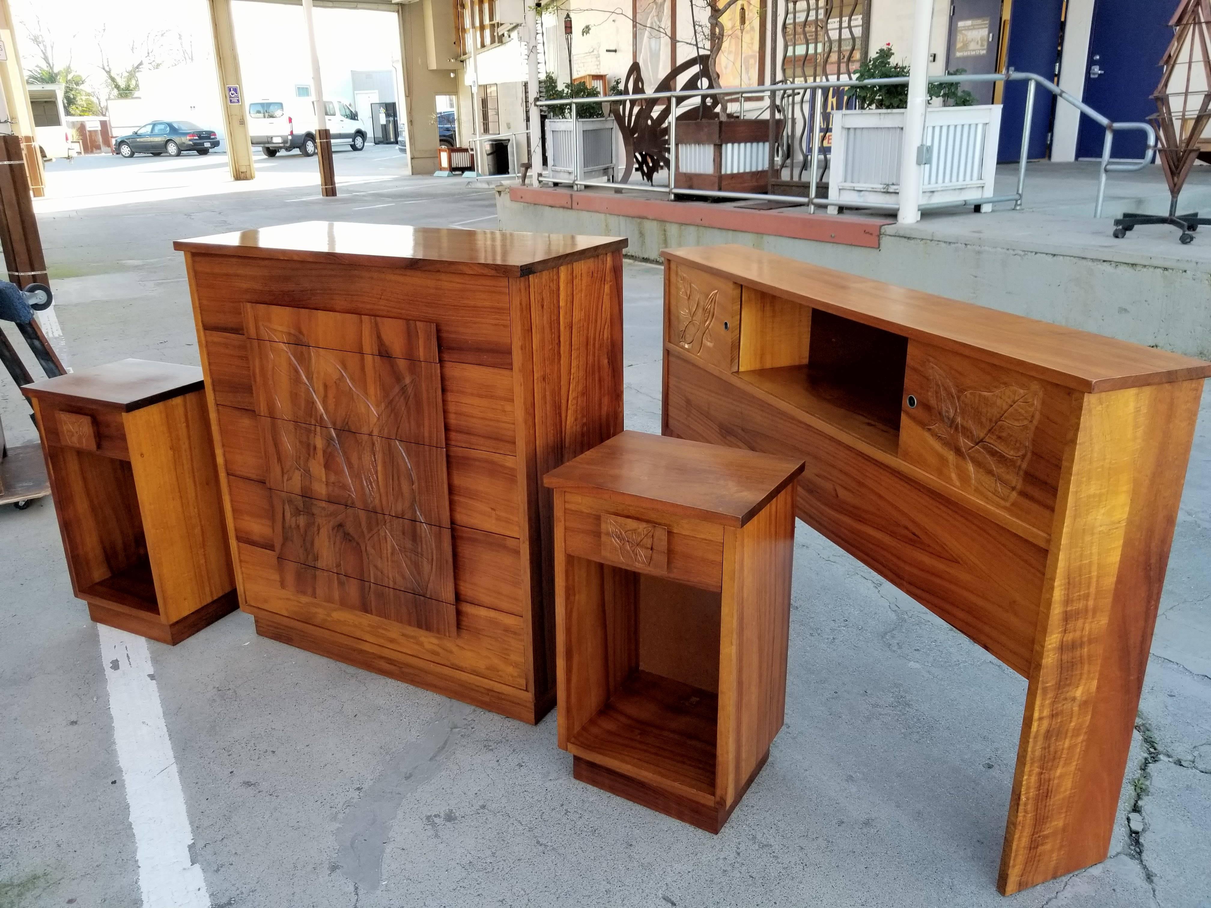 Outstanding and scarce four-piece Hawaiian Koa Polynesian style bedroom suite. Organic hand-carved anthuriam floral detail. Beautiful glow to original finish. Crafted in solid Koa and Curly Koa woods in Hawaii, circa 1960s.  Night stands measure