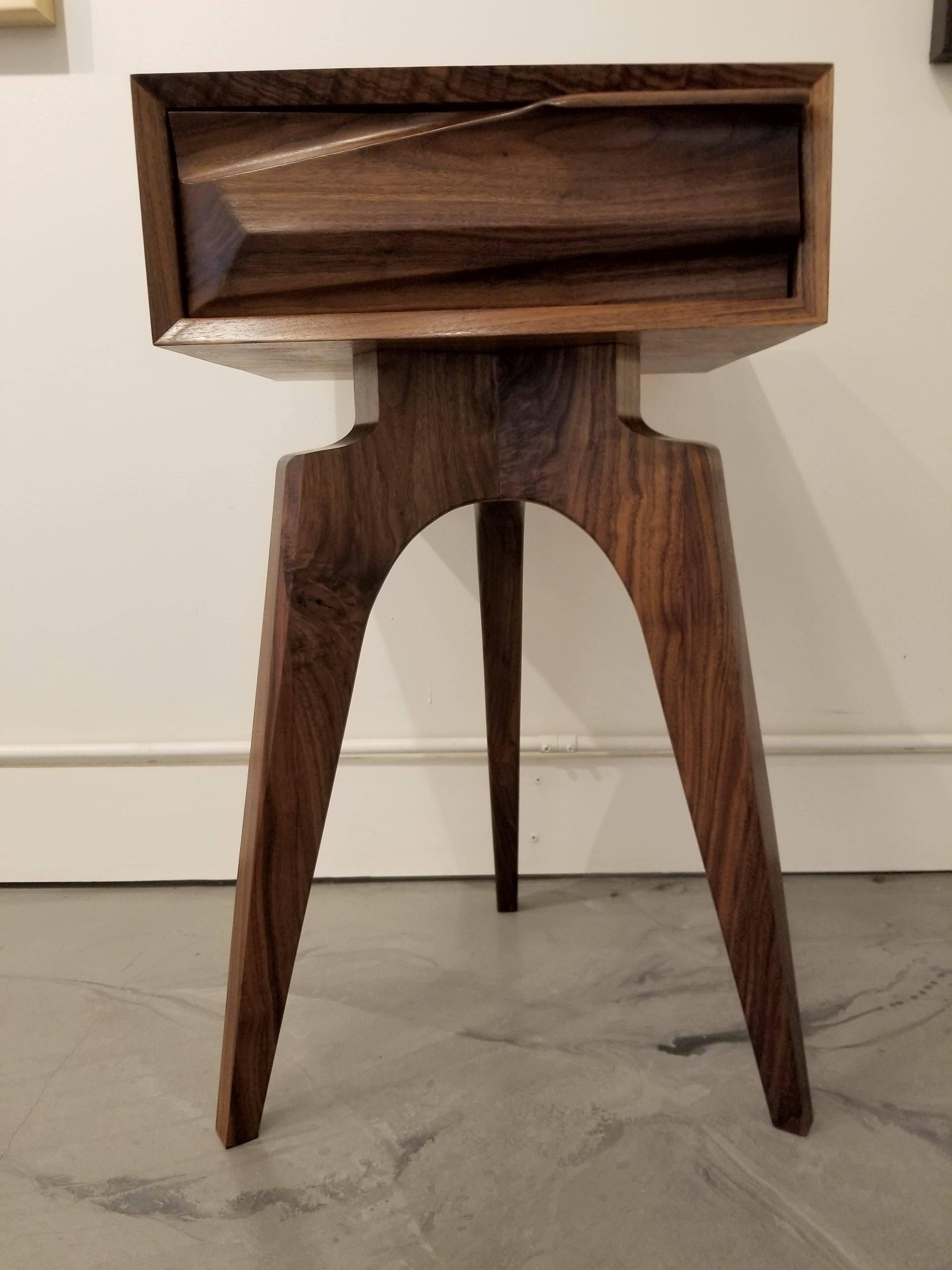 Gracefully handcrafted sculptural end table with modernist tripod base. Exceptional figured solid black walnut construction. Secondary woods are solid walnut. Drawer front design inspired by the Pacific Ocean waves. Very nice one-of-a-kind piece.