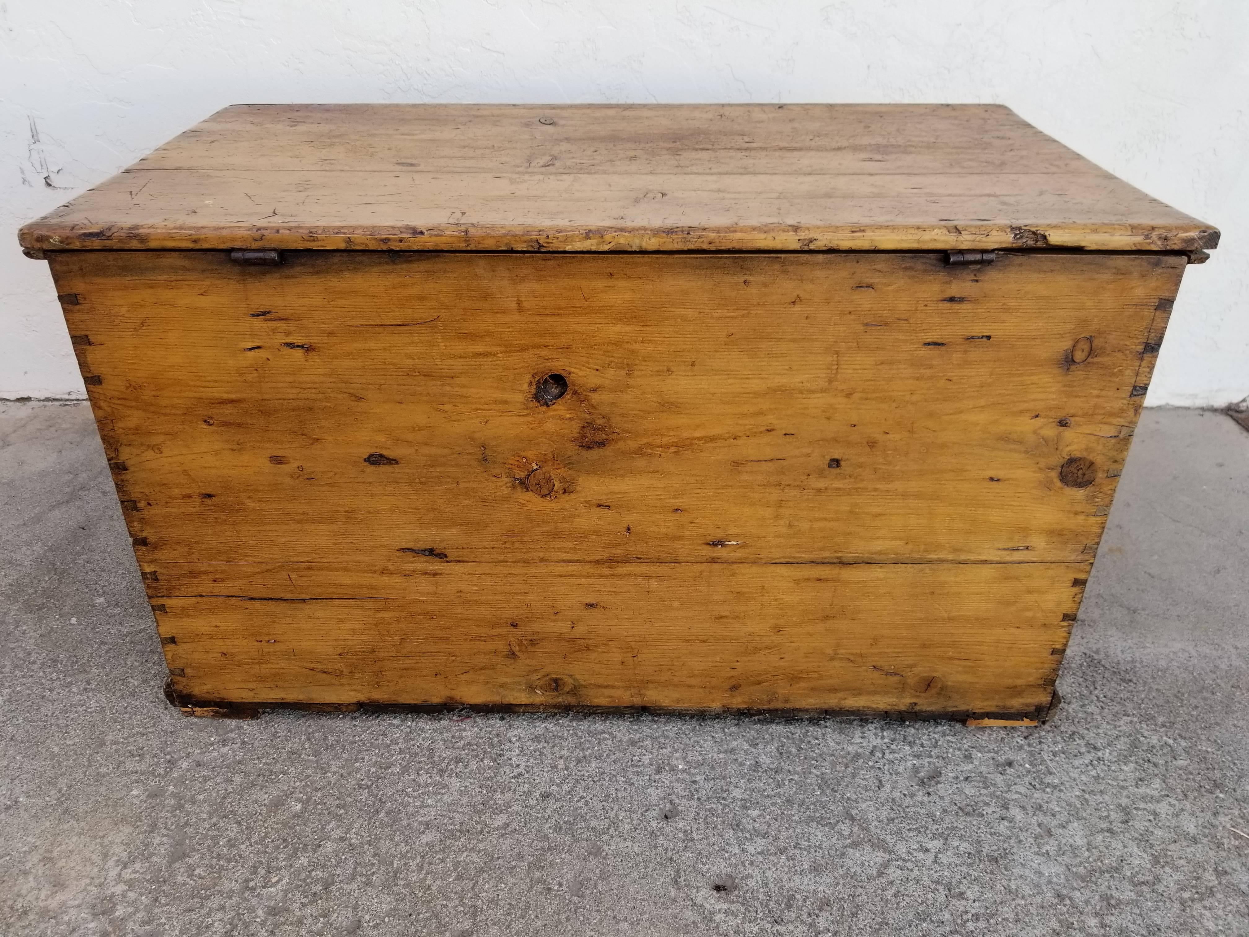 Handsome 19th century pine trunk with a beautiful patina. Hand scribed dovetail construction, original wrought iron hinges. Nice as an end table or coffee table with storage.