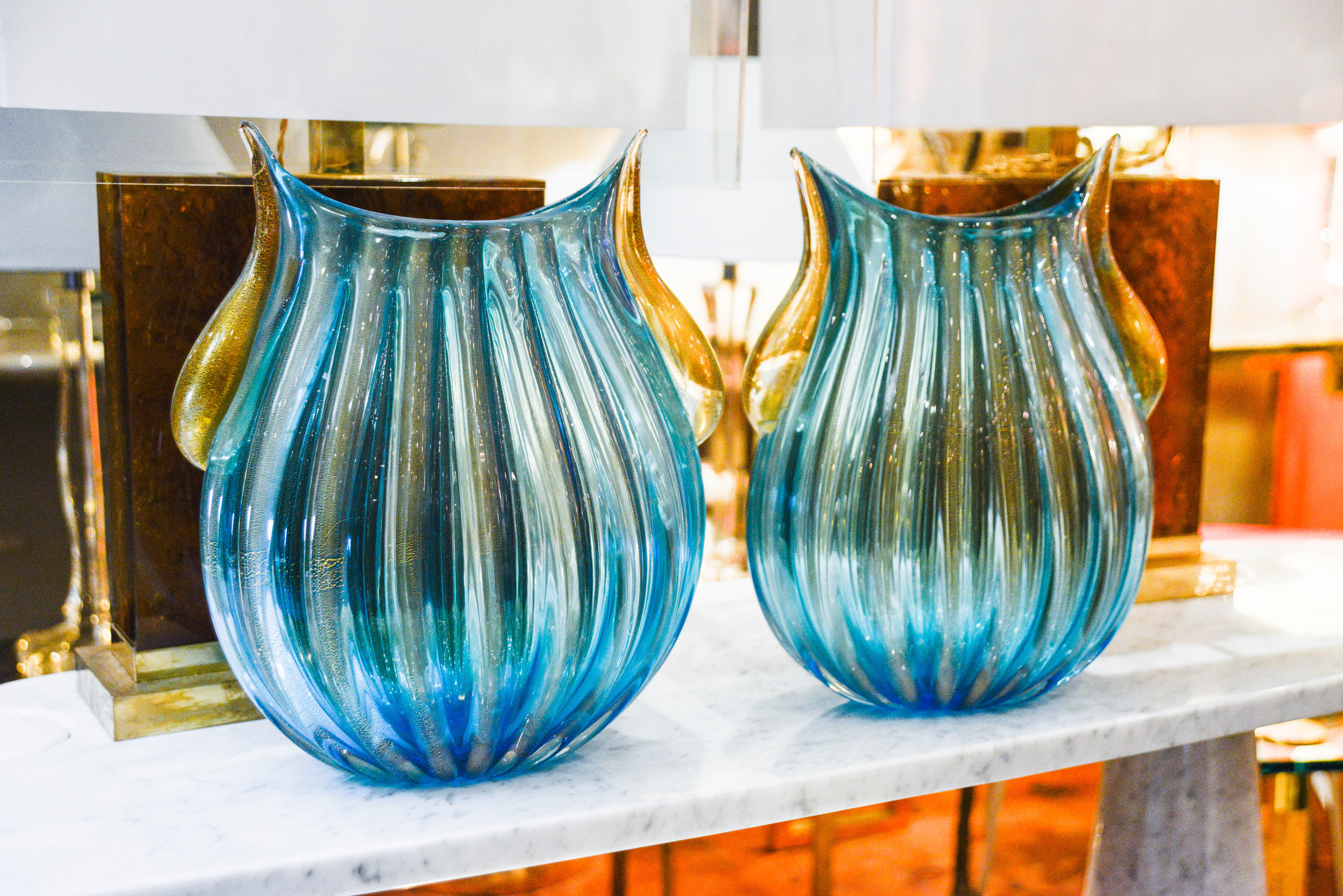Pair of blue glass vases with golden leaves tears.
