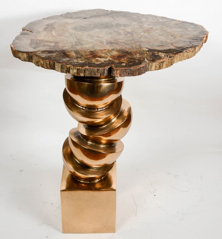 Pair of bronze tables with petrified wood top.