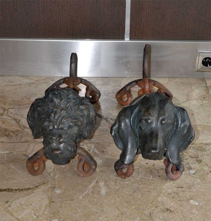 Two dog andirons signed by Dupond and dated 1939, in metal.