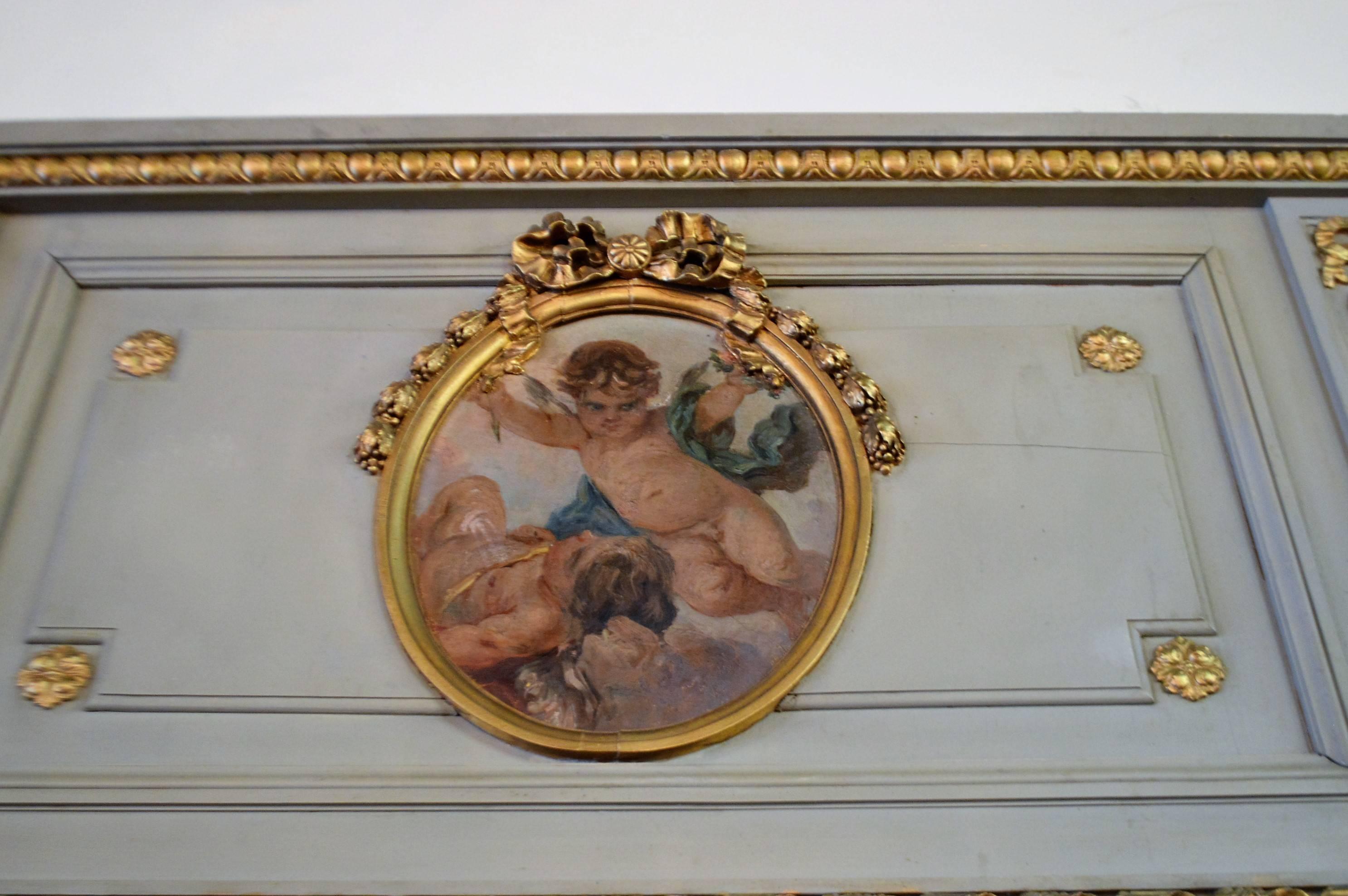 Louis XVI style, large and splendid painted trumeau mirror.
The oil painting inserted in the oval medallion represent cherubs, the medallion is framed with gilded molding and the Louis XVI bow details at top.
The patina on the frame is a lovely