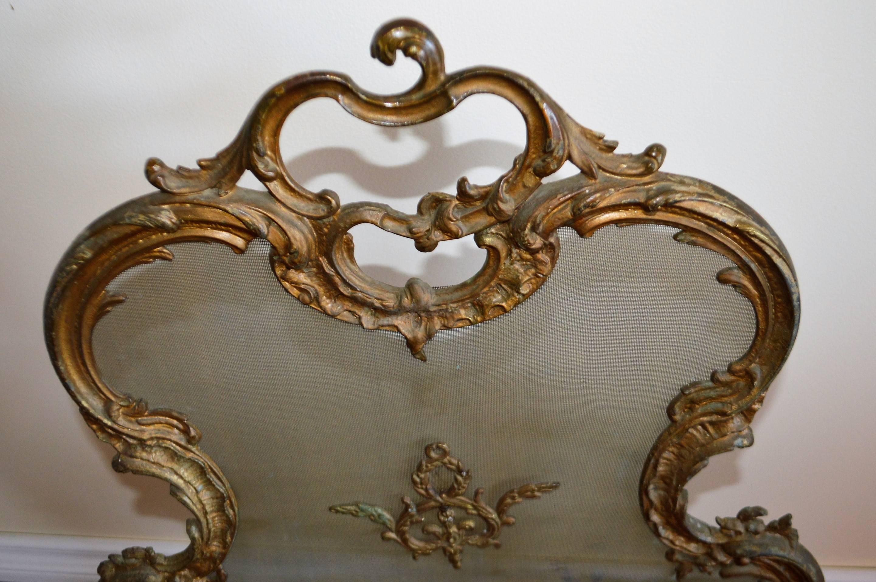 Highly decorative bronze fireplace screen, perfect for a small cozy fireplace.