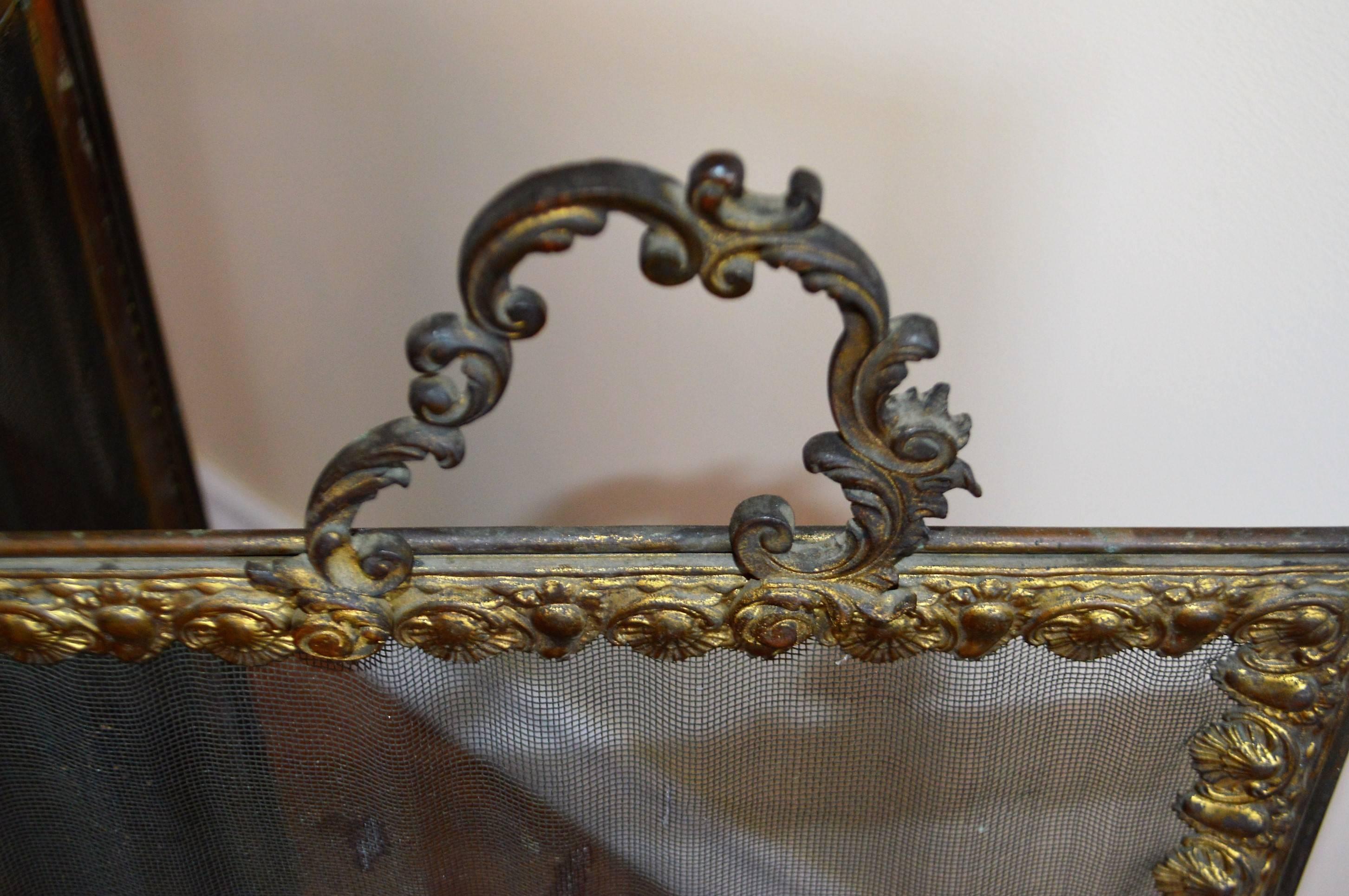 Lovely three sides folding fireplace screen with pretty bronze carved gilded decorative elements around the edge of the screen.