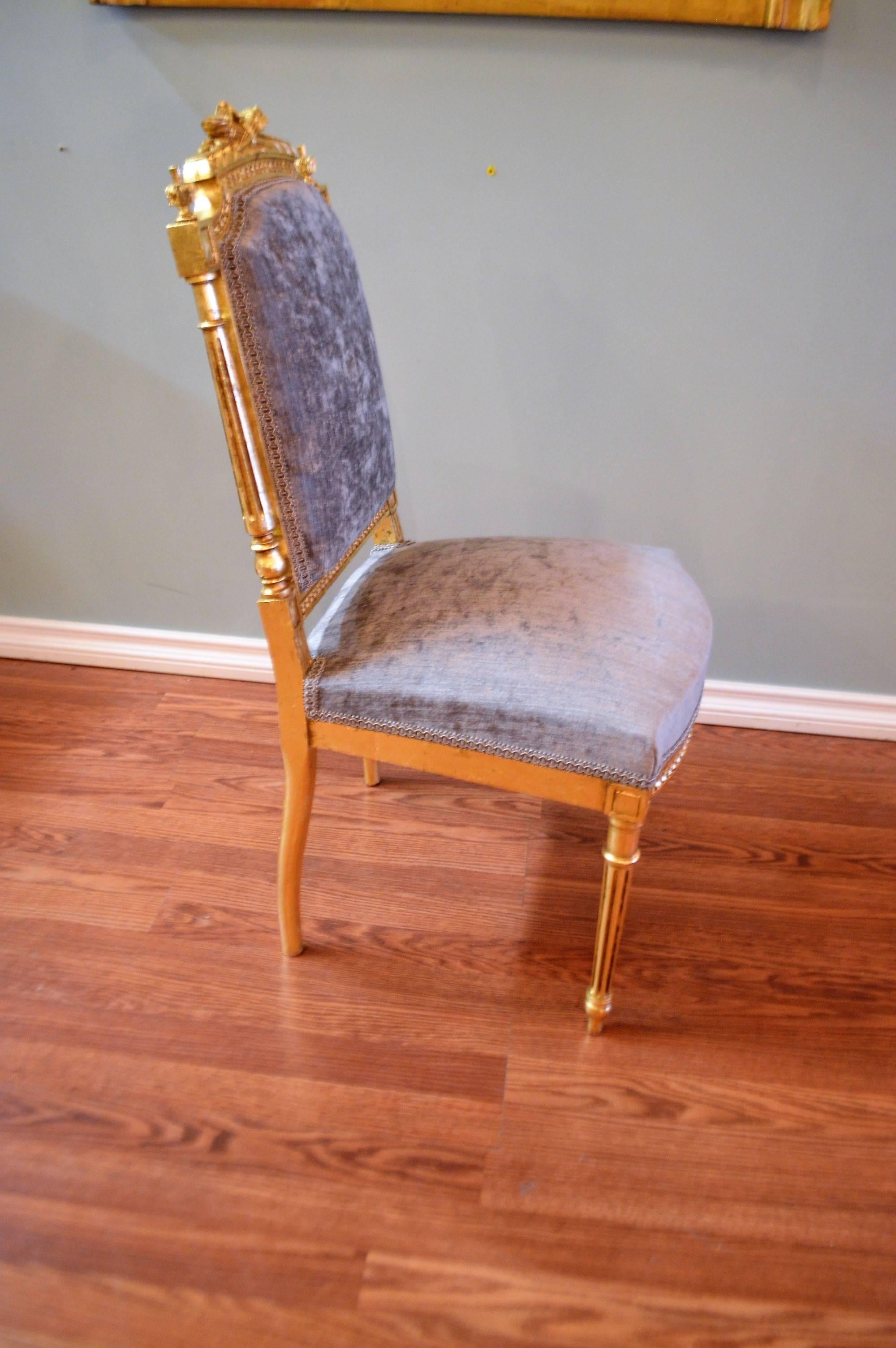 Pair of Louis XVI style gilded side chairs, great for entrance way and the flank console, commodes. The frame is of 19th century, the gilding has been
retouched, they have been newly upholstered in a grey with a hint of blue velvet chenille fabric.