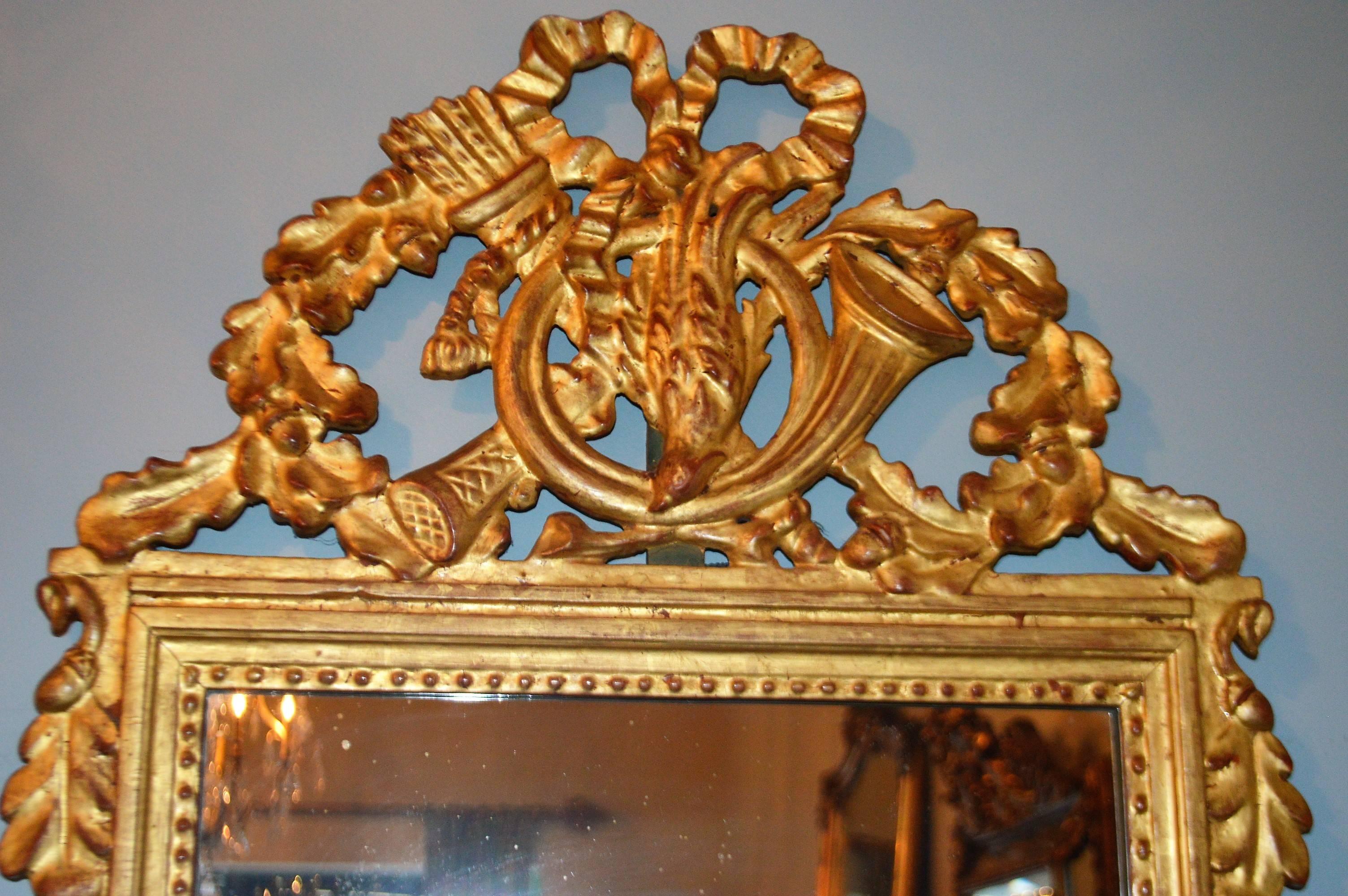 French Louis XVI Style Highly Decorative Gilded Mirror For Sale