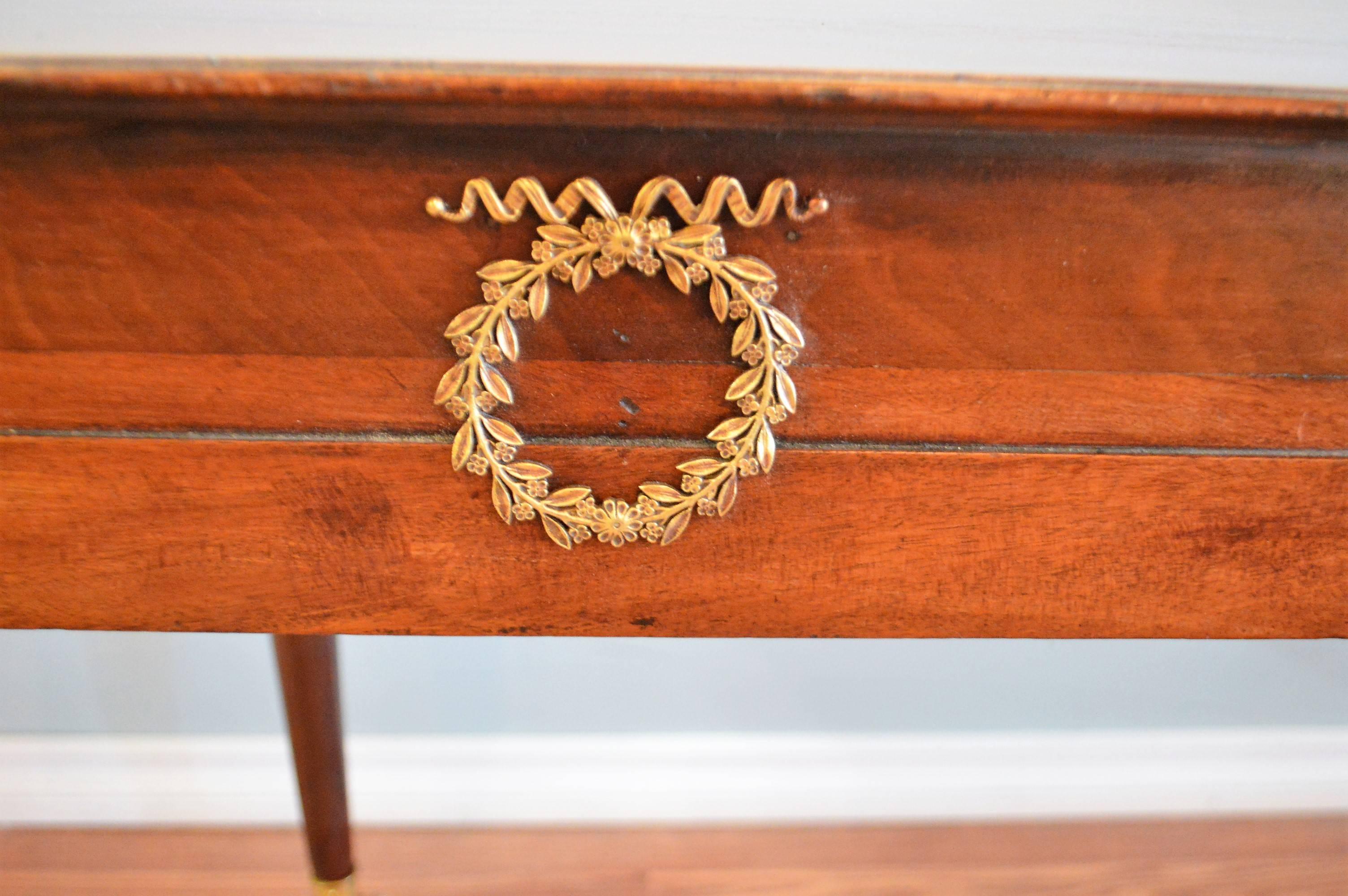 Handcrafted elements to this unique mahogany console that could also work beautifully for a sofa table. The front of the console has one drawer.
Lovely and fine bronze wreath decorative hardware at the front of the table.