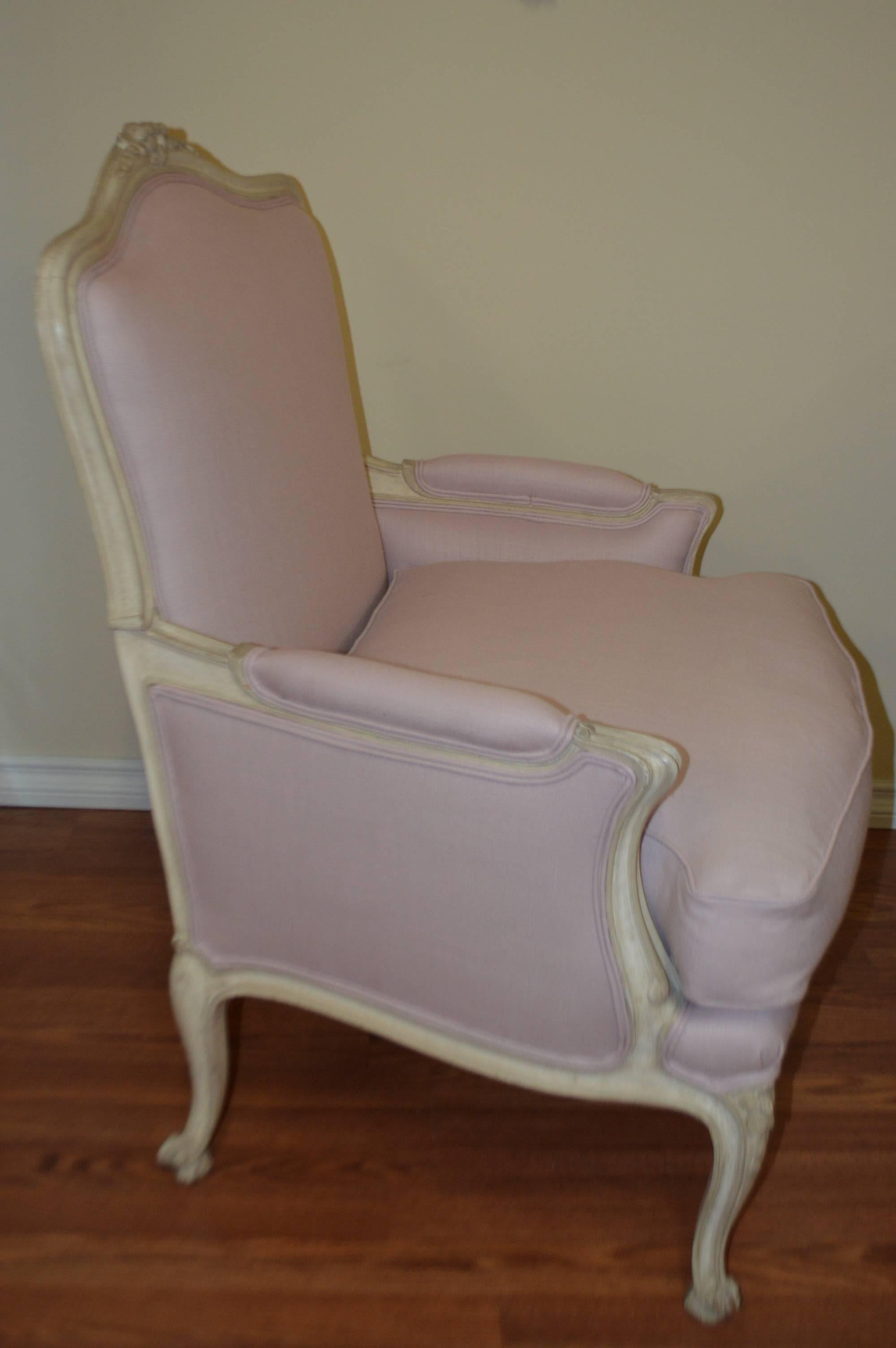 Louis XV style painted bergere chair, generous size, very comfy with feather and dawn seat cushion. The frame has the original patina and it has been newly upholstered with a lavender tone linen.