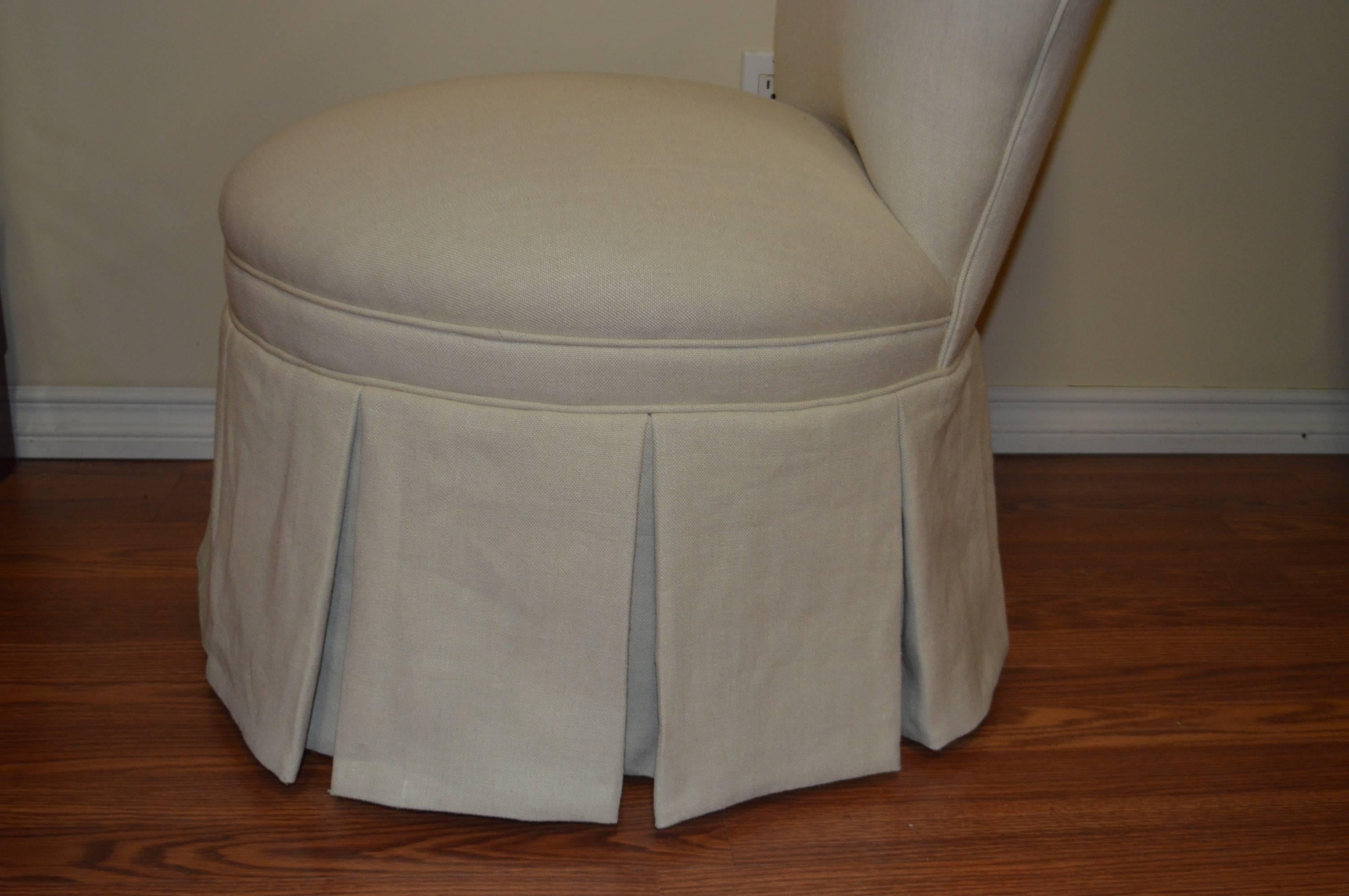 Lovely and comfy vintage slipper chair newly upholstered in a beige linen fabric.