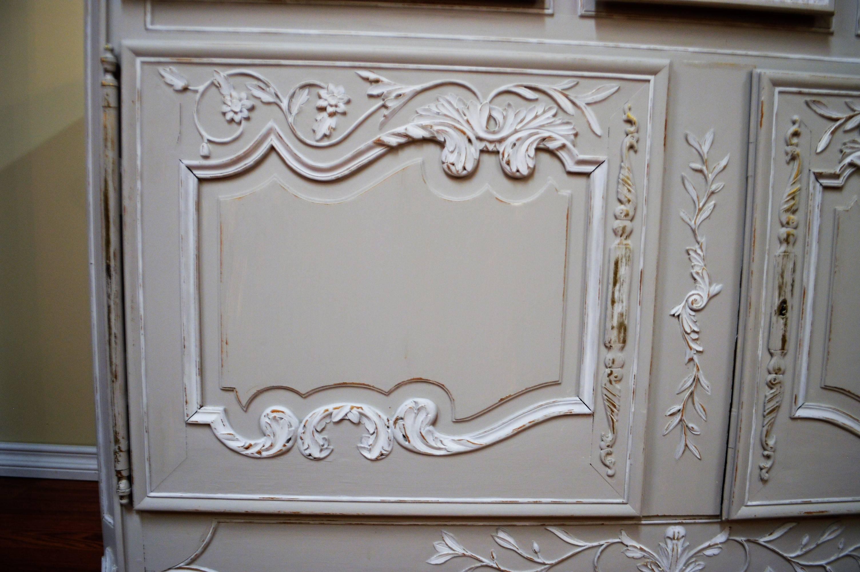 Louis XV style painted buffet or cabinet over solid cherry in a light grey with antique white details. There are three drawers and a large compartment for storage. One shelf will be added to the interior for storage.
All of the exterior details