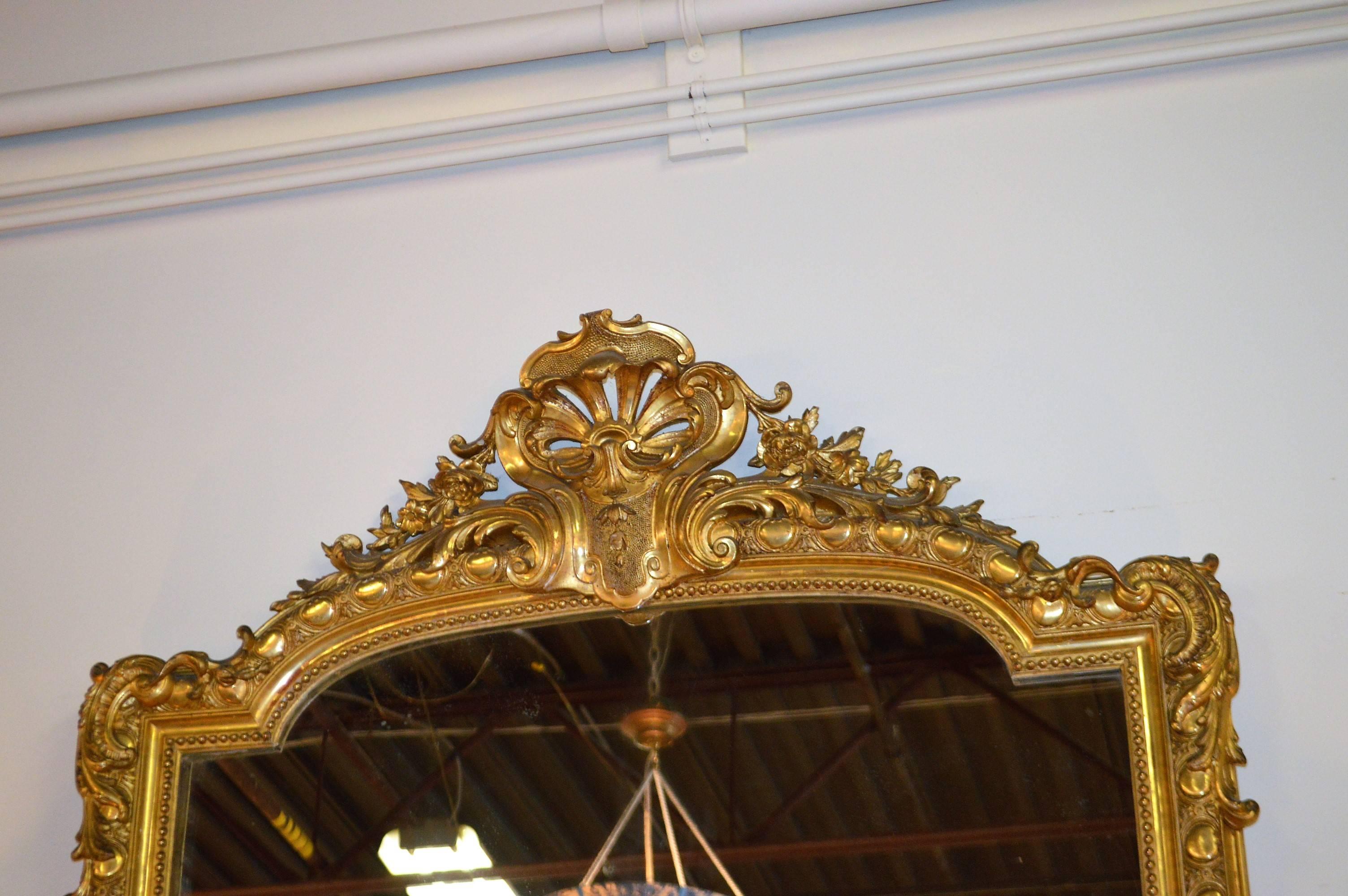 Stunning 19th century gilded on wood large mirror in the style of Louis XV with decorative shell and acanthus leaf design. An impressive and beautiful mirror and very good condition despite its age.