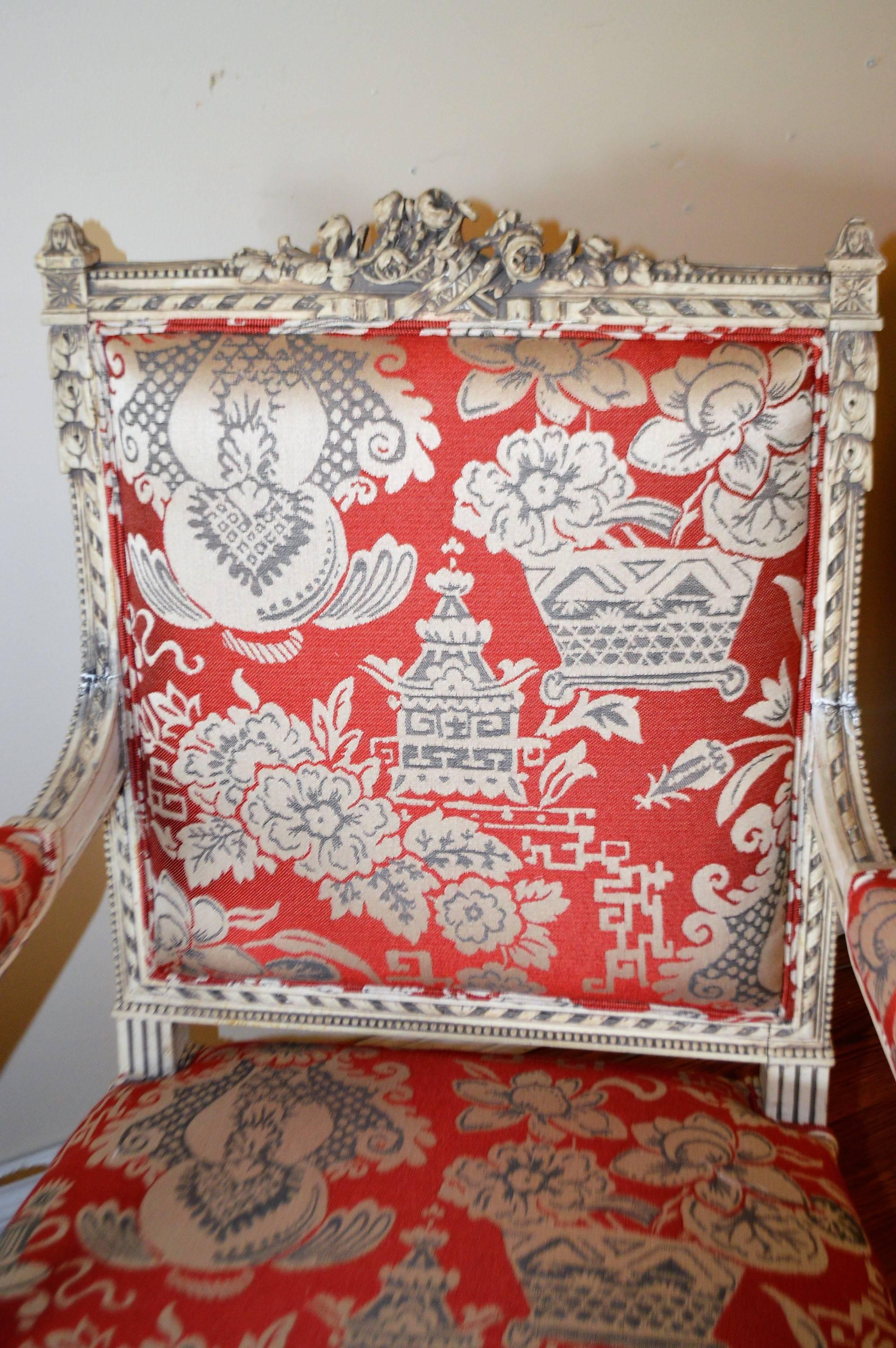 Amazing hand-carving details on these 19th century painted armchairs.
The frame painted finish has been kept original but the upholstery is newly done using a fine weave fabric with a chinoiserie pattern.
The fabric background color is red