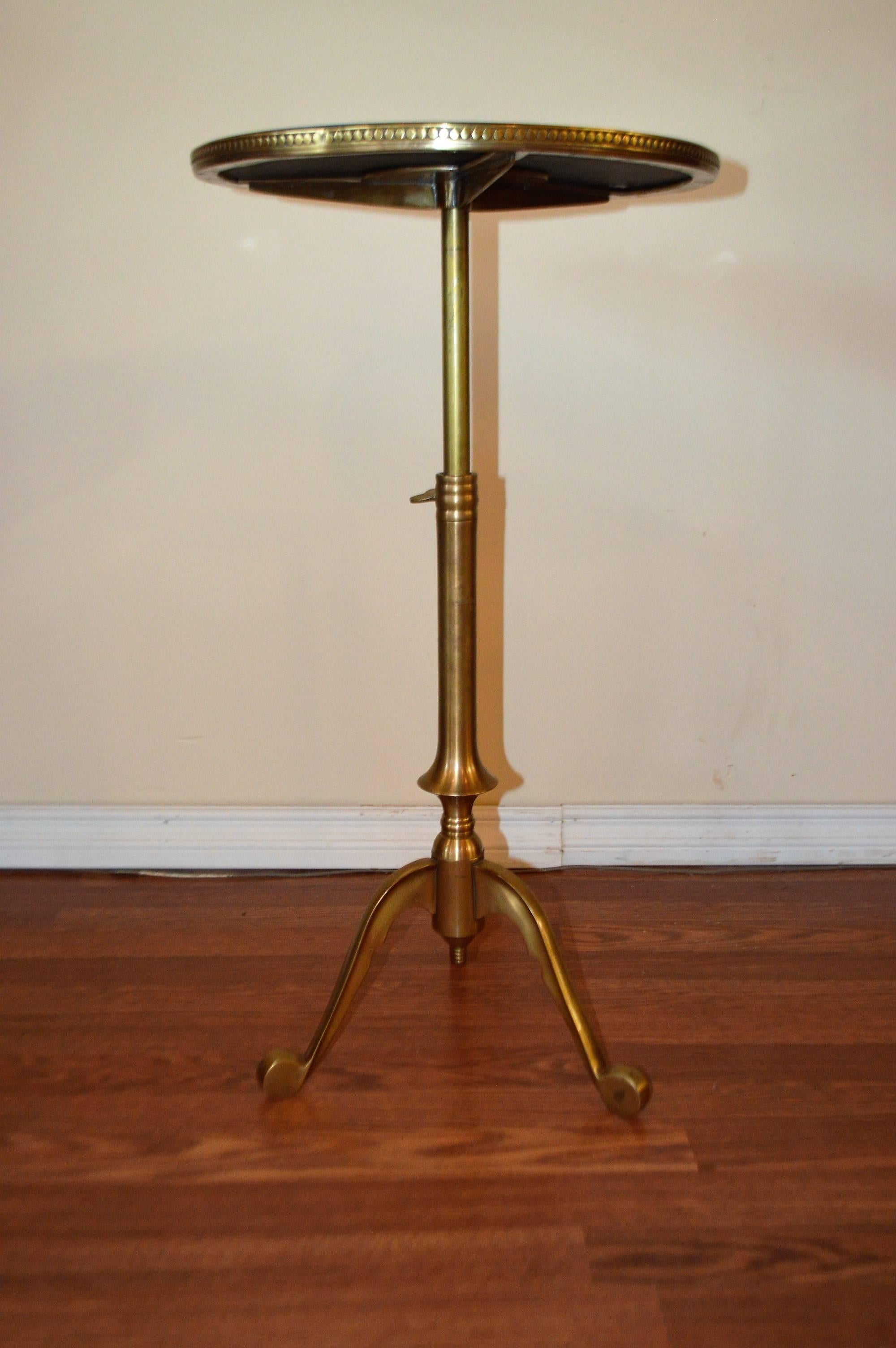 Decorative, fine quality, polished brass base side table, tripod style, nesting on three legs, it will extend to 31