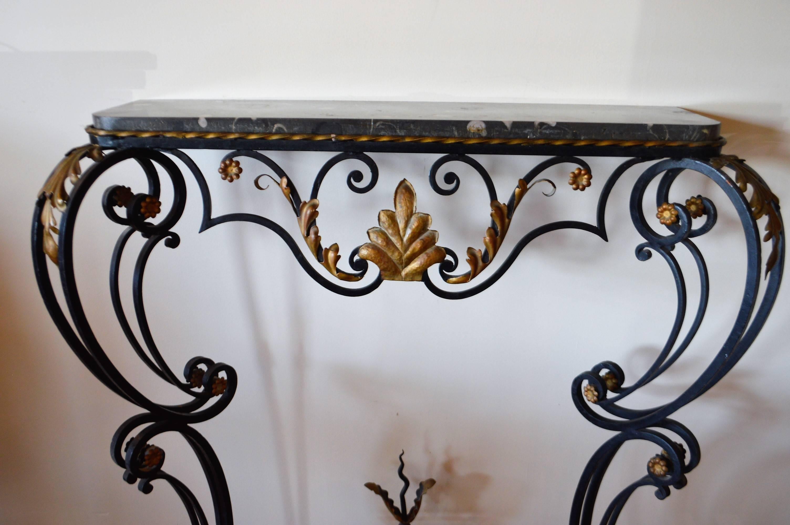 Louis XV style hand-forged with some gilded acanthus leave and flower design and dark grey marble top. Very Belle Époque stylish and perfect for space requiring shallow depth.