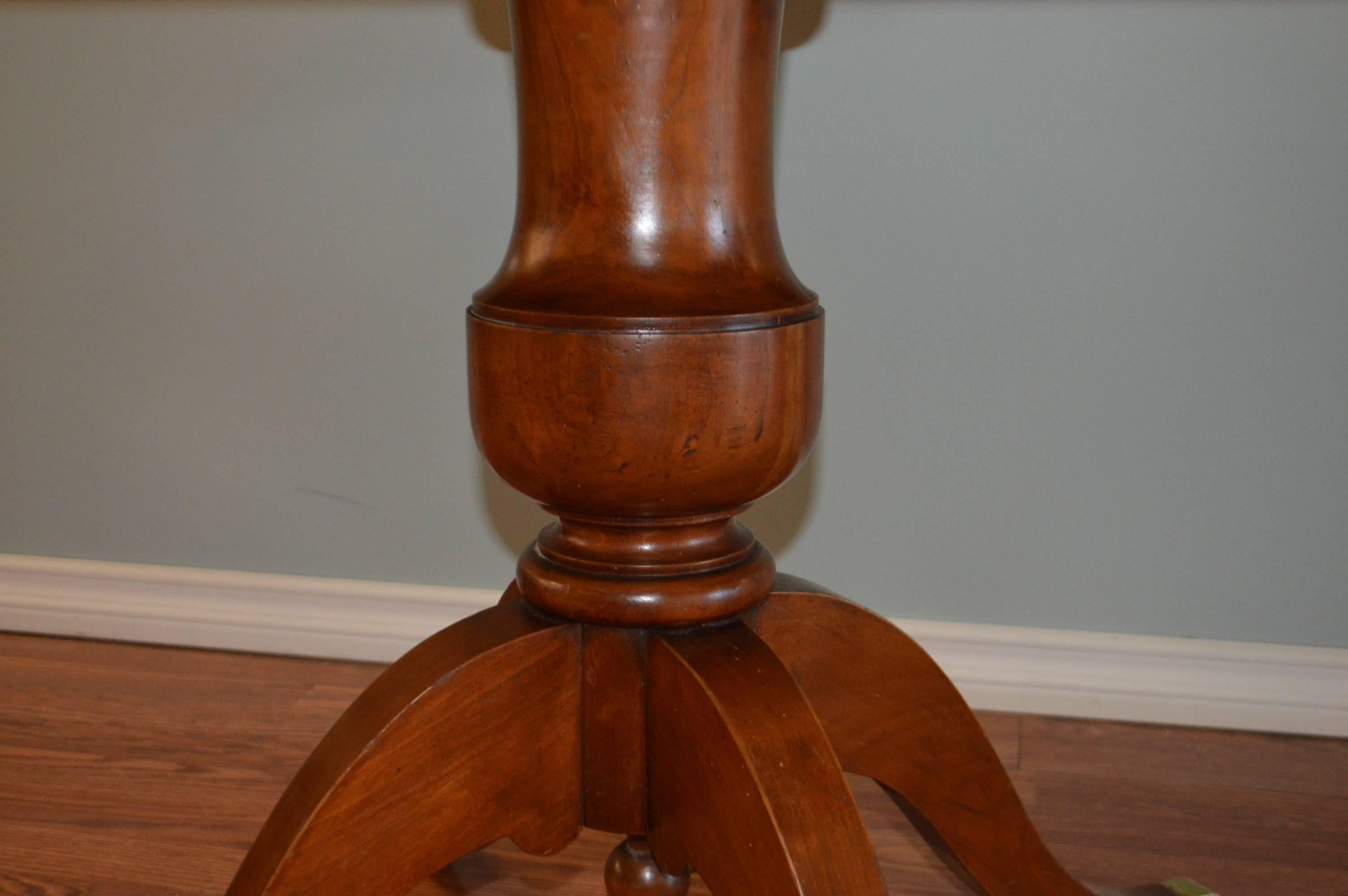 Warm patina on this Louis Philippe style walnut round table. The center pedestal is made of solid walnut and the four feet have brass plates. Great as is for a breakfast table or entrance table.
There are three leaves of 19 1/2