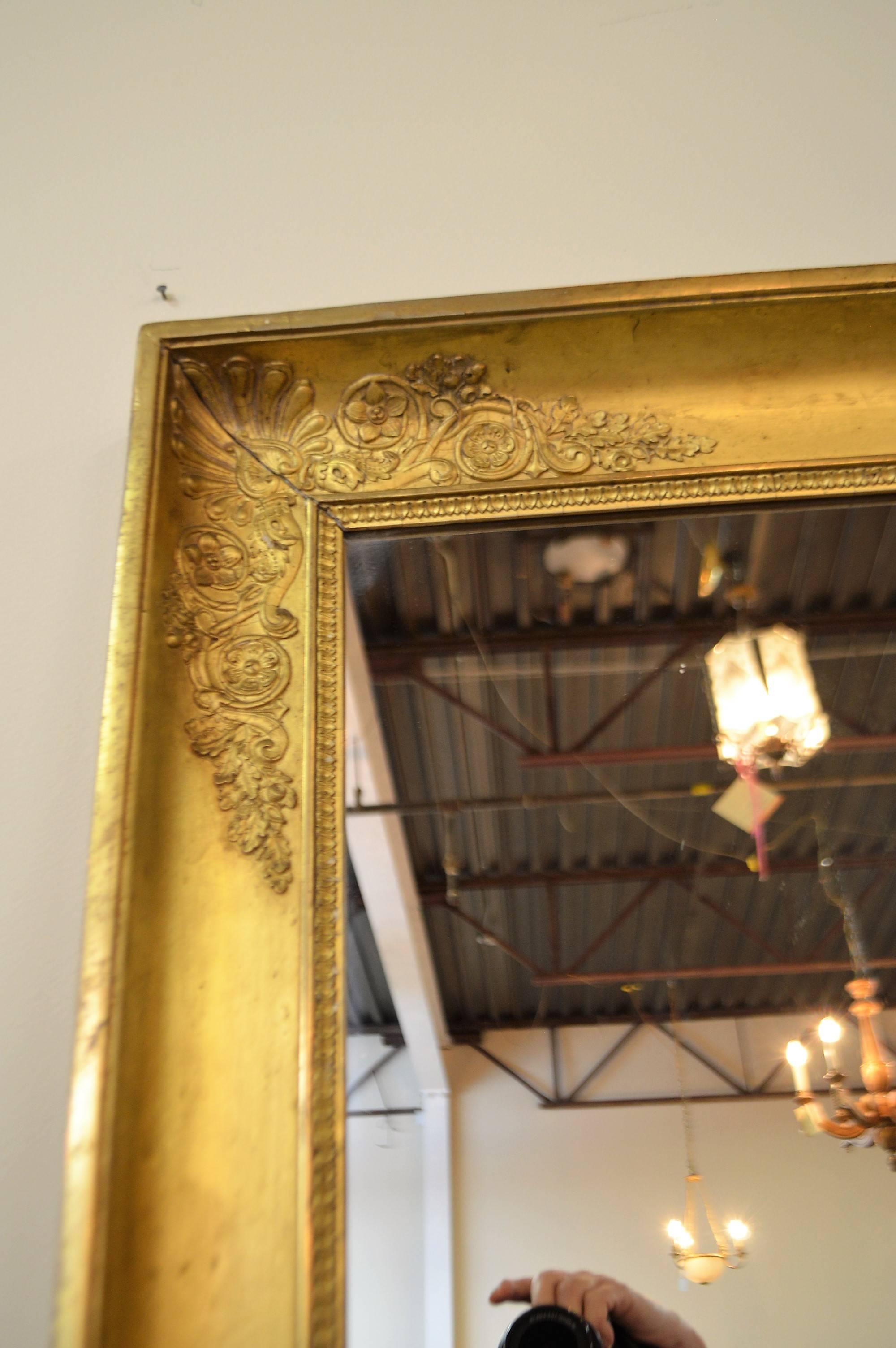Mid-19th century Directoire style gold leaf mirror, will fit many decor, simple and elegant with only palm leaf decor on each corner.