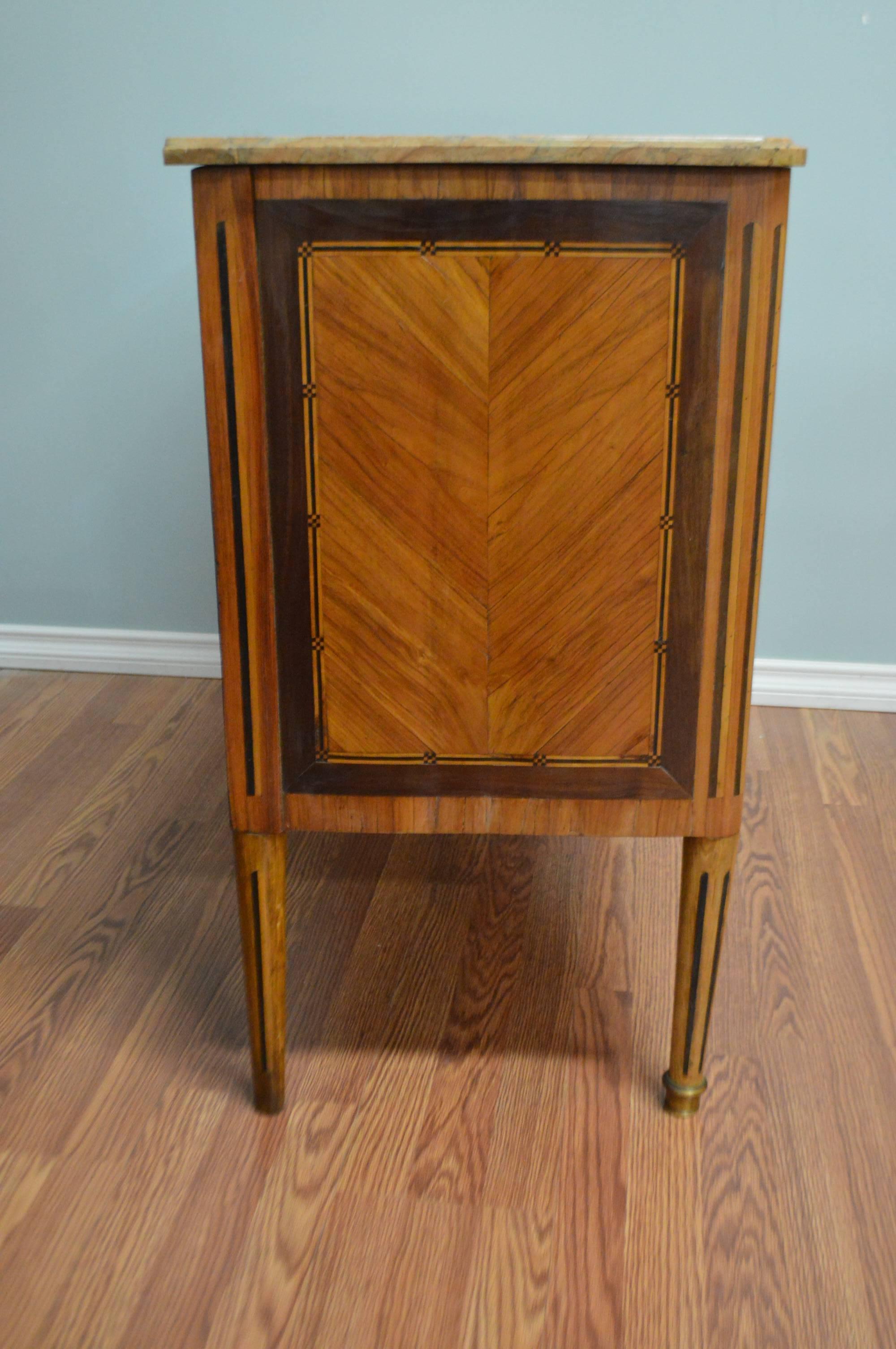 18th century, Louis XVI commode with bronze hardware fine in-lay wood and the original beige marble top.