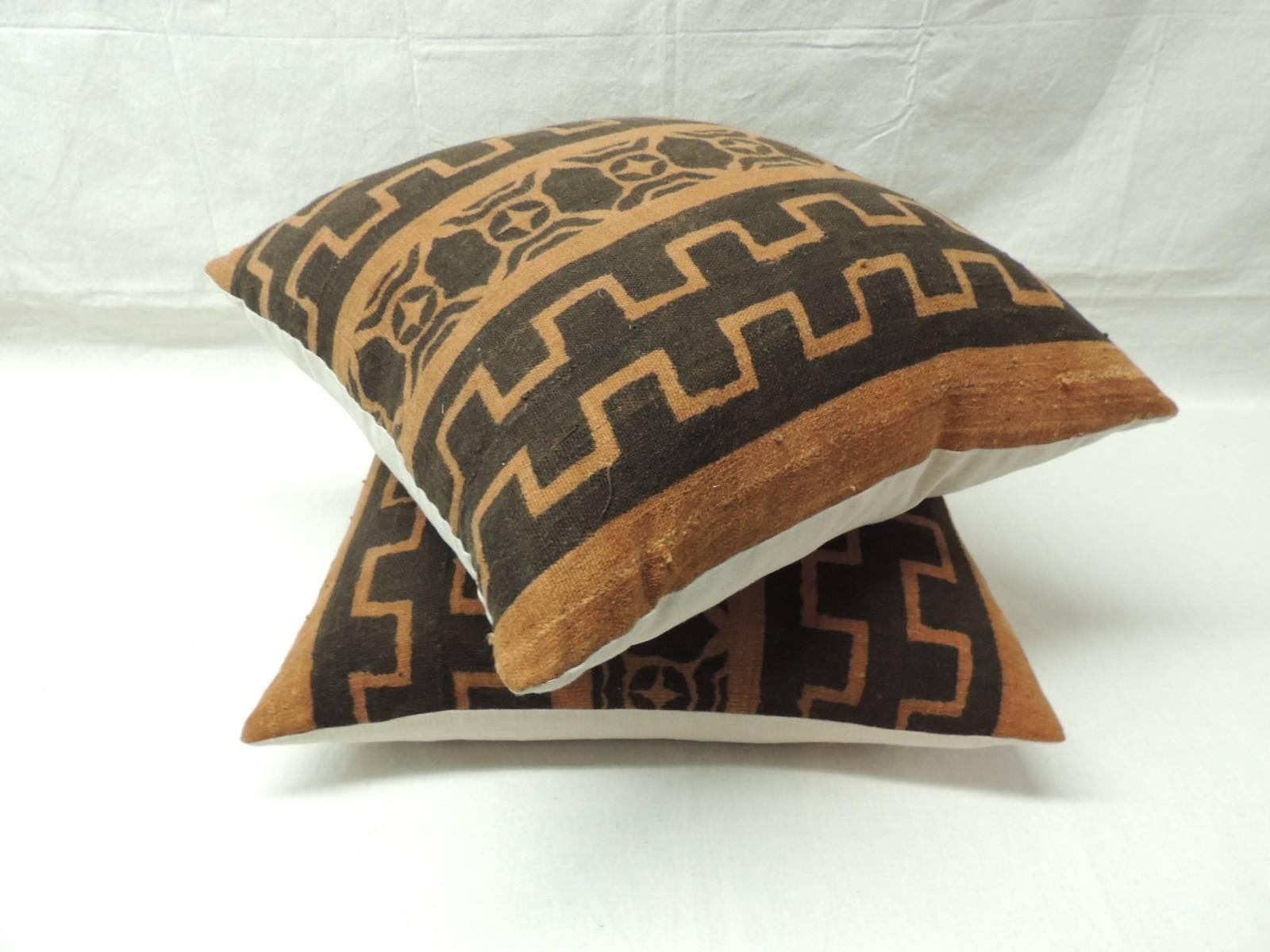 Pair of vintage African pillows with tribal design in a mud cloth. Traditional tribal design in shades of light and dark brown with natural textured linen backing. Handcrafted and designed in the USA with custom-made pillow inserts. Closed by hand