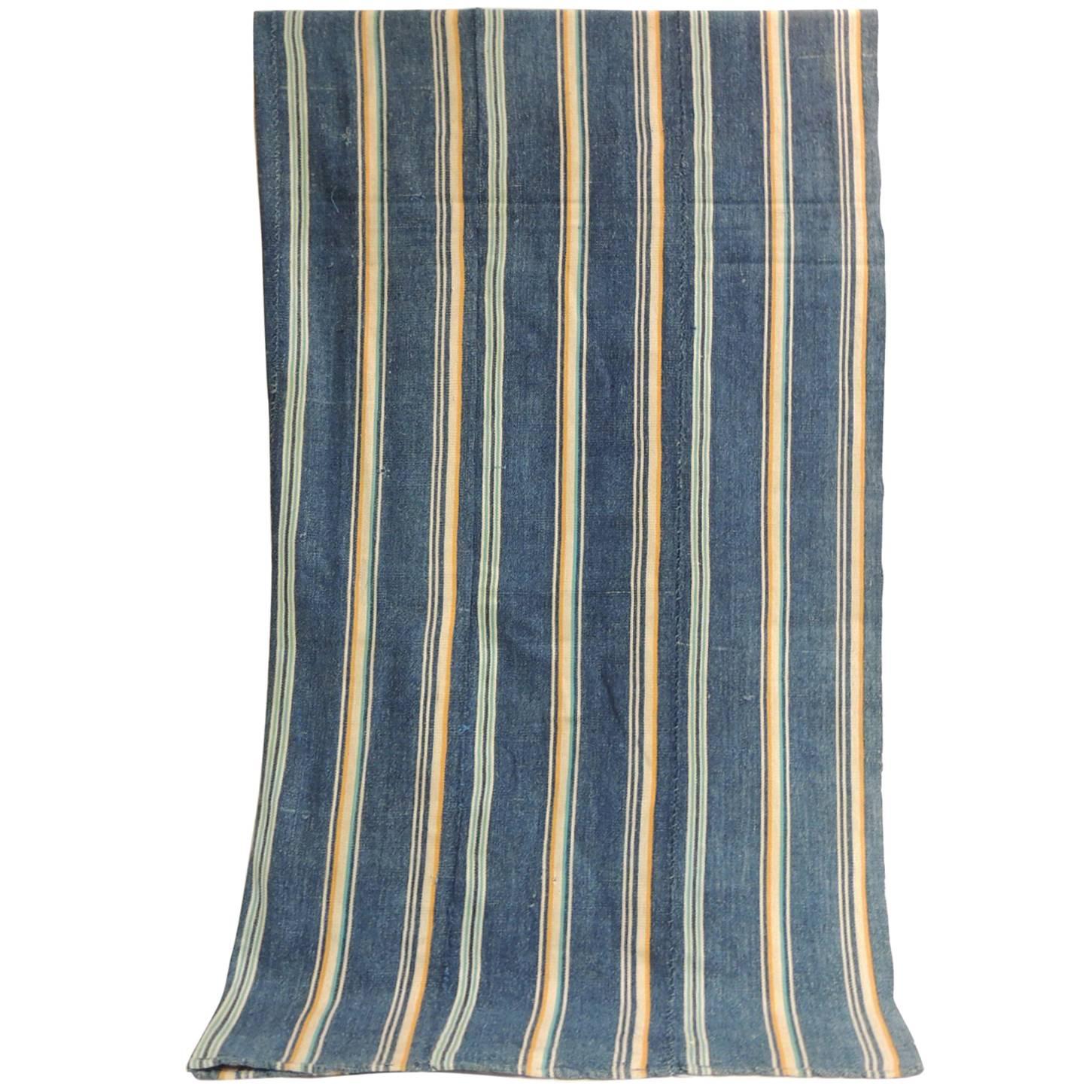 Vintage Yoruba and Baulé warp ikat artisanal cloth. West Africa vintage Yoruba and Baulé warp ikat. In shades of blue, natural, aqua and yellow.
Ikat is the process whereby threads are tie-dyed before weaving takes place. When the cloth is woven,
