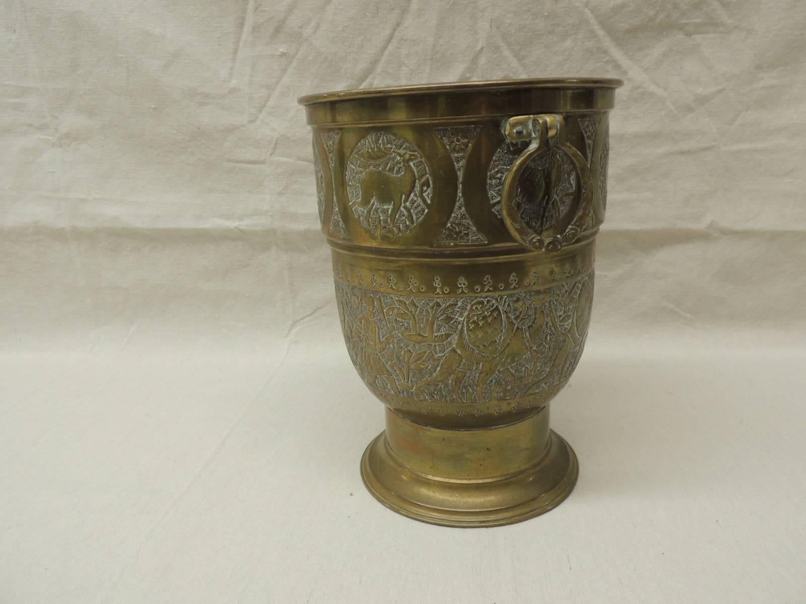 Persian brass ice bucket with handles, depicting deer and a caravan of camels all around. Round handles and aluminum bucket liner.