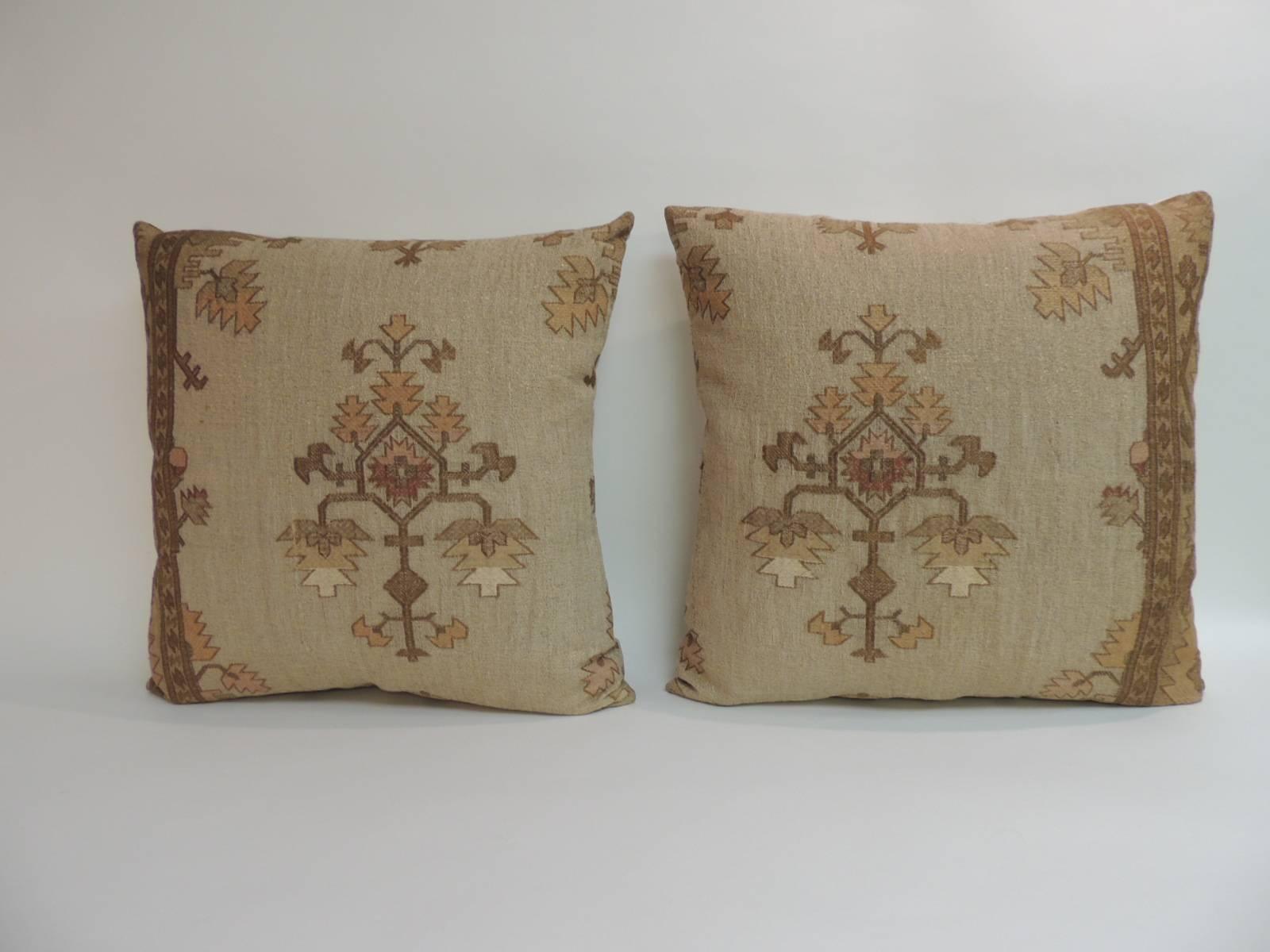 Pair of 19th century embroidered Turkish throw pillows geometric, gold metallic on silk 
undertones with embroidered flowers in pink, yellow, rust and orange with a silver/grey silk backings.
Handcrafted and designed in the USA with custom made