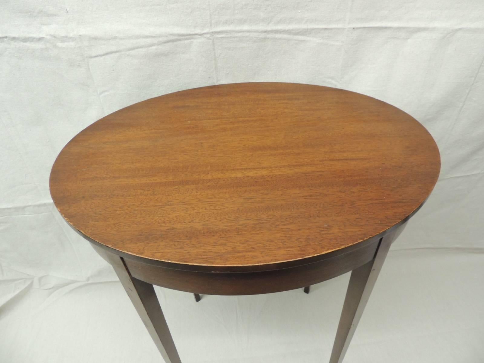 Vintage oval wood side table with square tapered legs. Original company labels.
Imperial’s primary product was tables, with the addition of bookcases to its line later in its history. Foote laid claim to inventing the “coffee table” after he helped